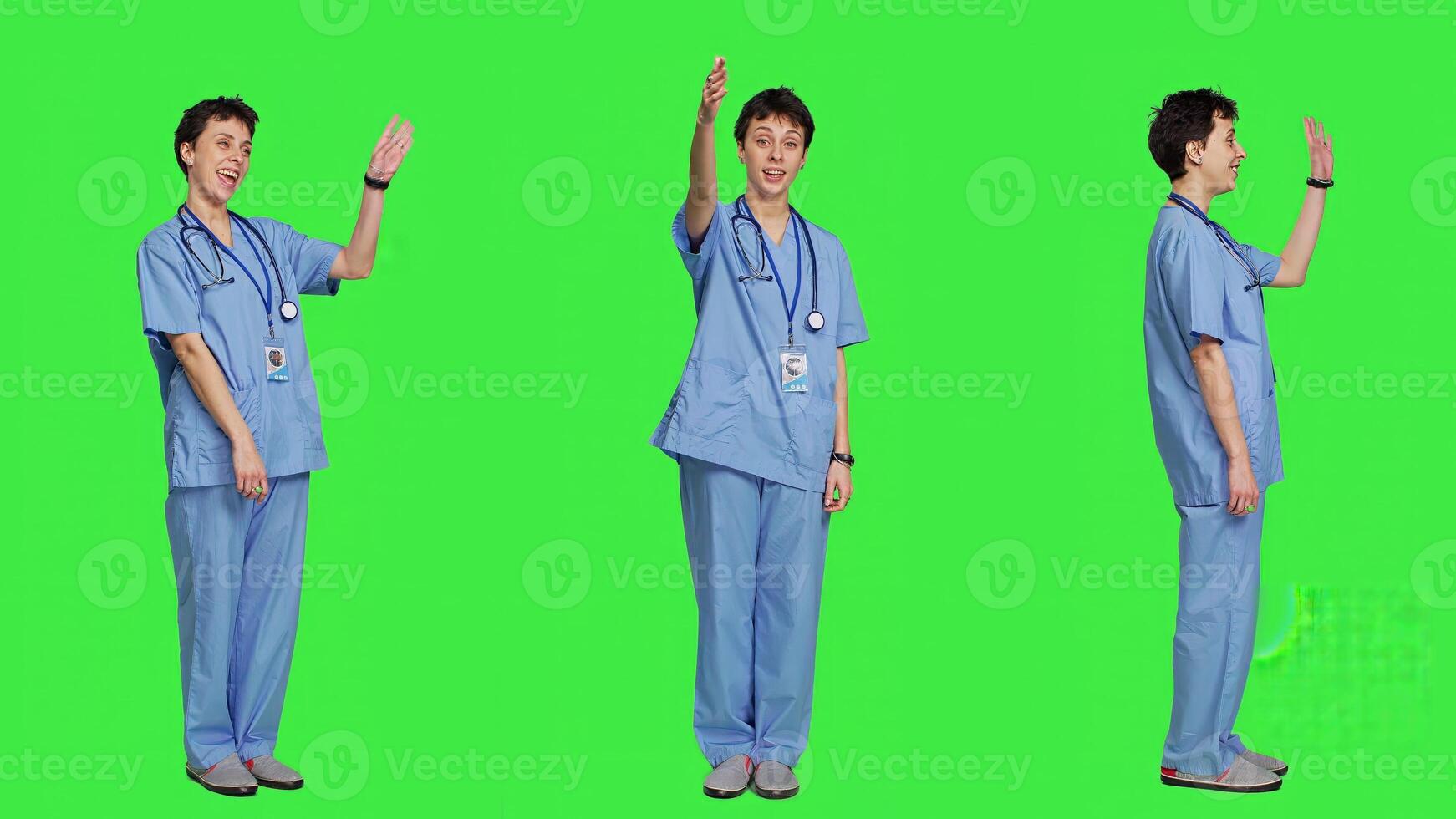 Woman nurse waving hello and inviting people to come closer, calling over patients for checkup examinations against greenscreen. Medical assistant greeting persons and asking them to come. Camera A. photo