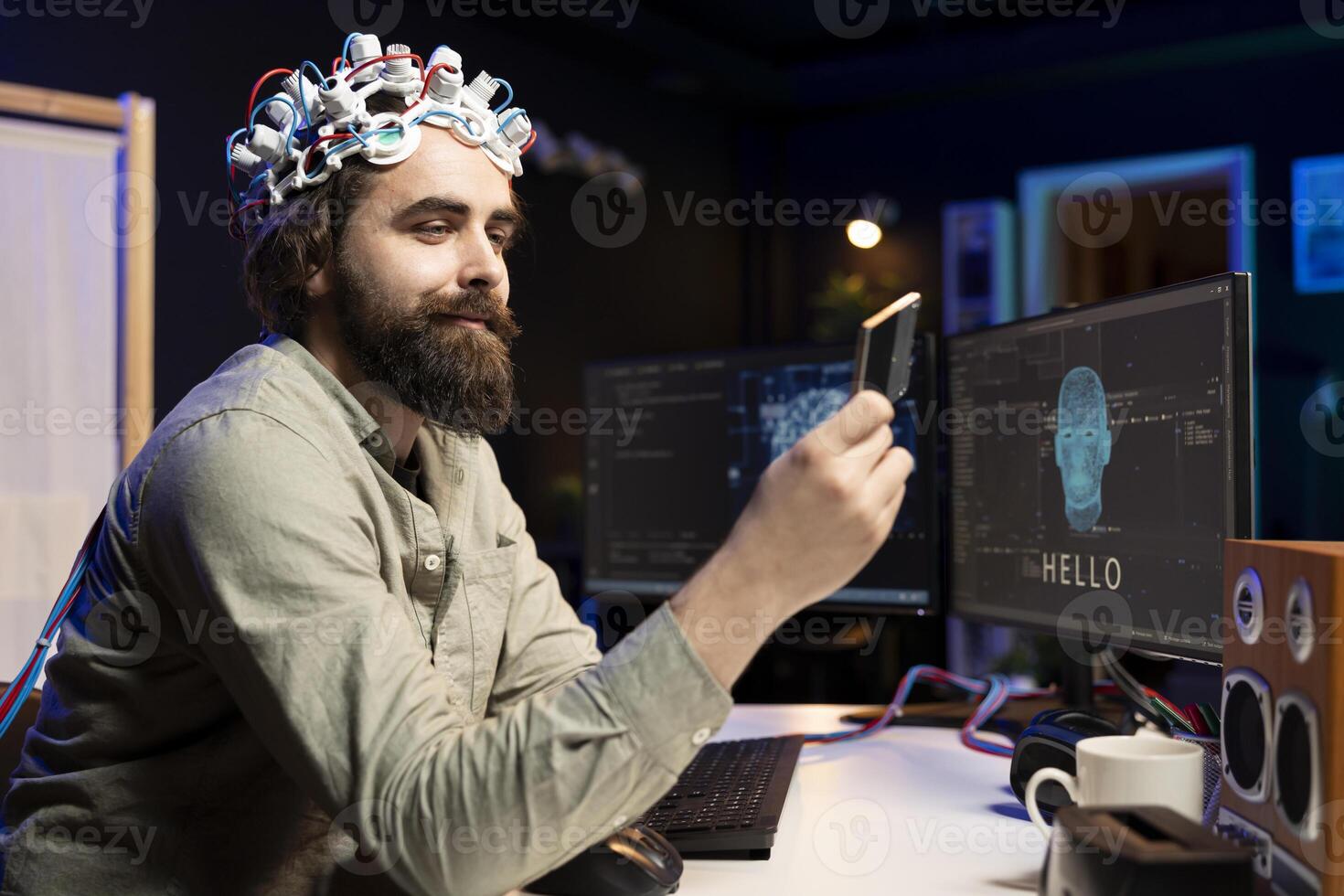 Smiling programmer wearing EEG headset holding disk containing software turning AI sentient, satisfied with finished product. Happy developer with cartridge able to awake artificial intelligence photo