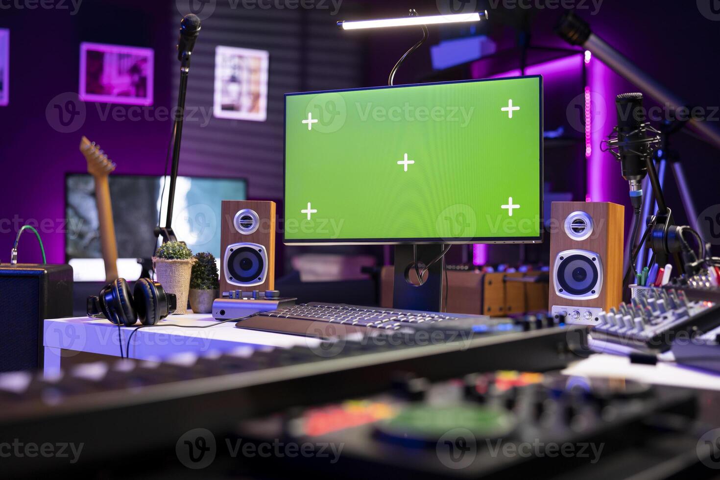 Empty space used for editing and recording music with electronic gear, acoustics instruments and mixing console. Home studio equipped with greenscreen on pc and post production tools. photo
