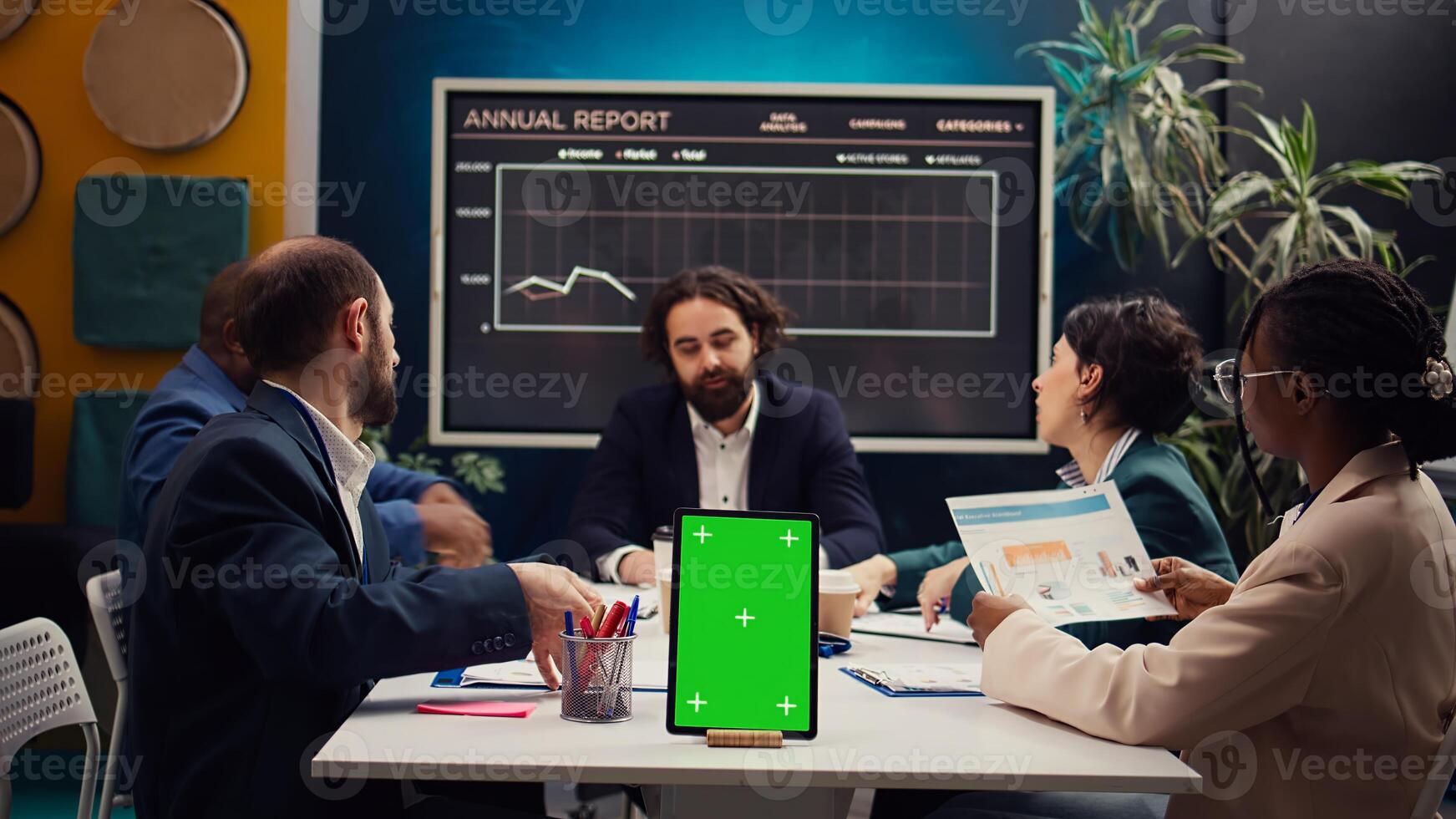 Chief information officer attends meeting with staff members next to isolated screen, discussing latest company achievements and success metrics. Business people share project updates. Camera B. photo
