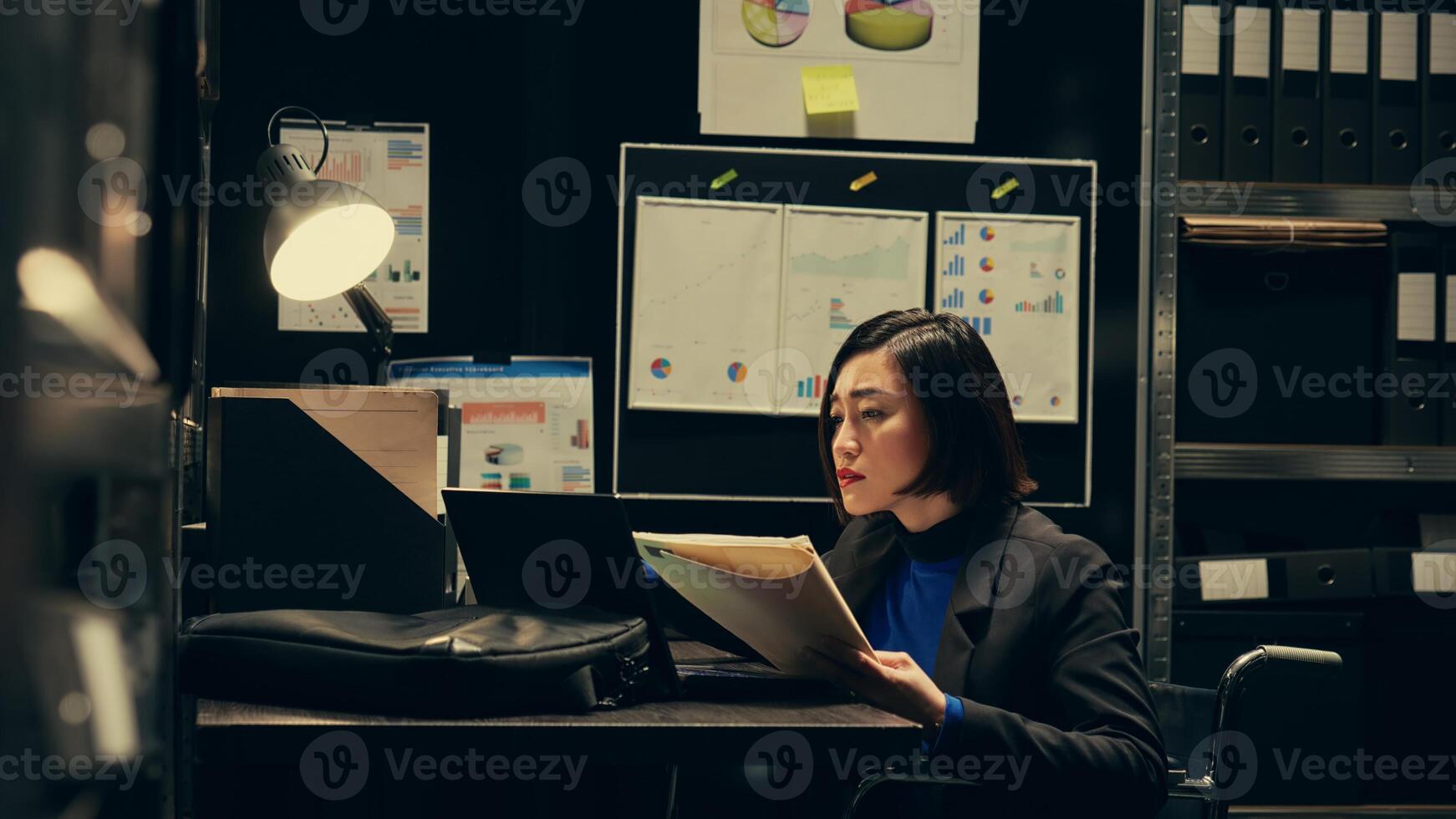 Agent wheelchair user reading witness statements and classified files, criminology expertise. Detective conducting private investigation, interpret archived legal documents. Camera B. photo