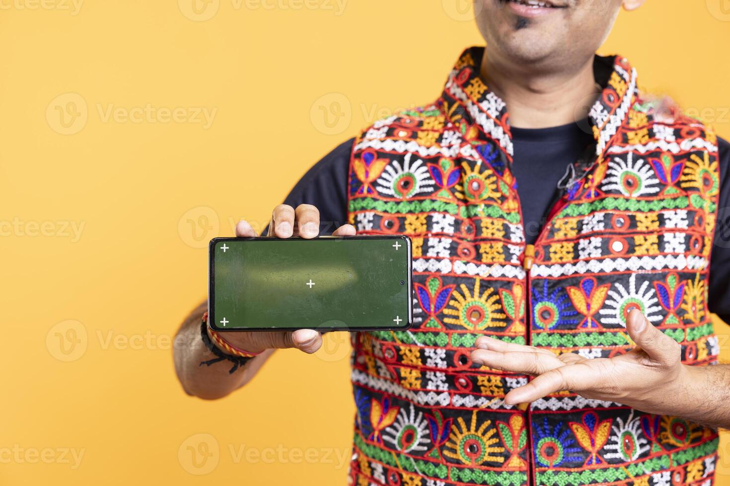 Influencer presenting green screen mobile phone in landscape mode, studio background. Close up shot of person holding copy space chroma key smartphone used for advertising brands photo