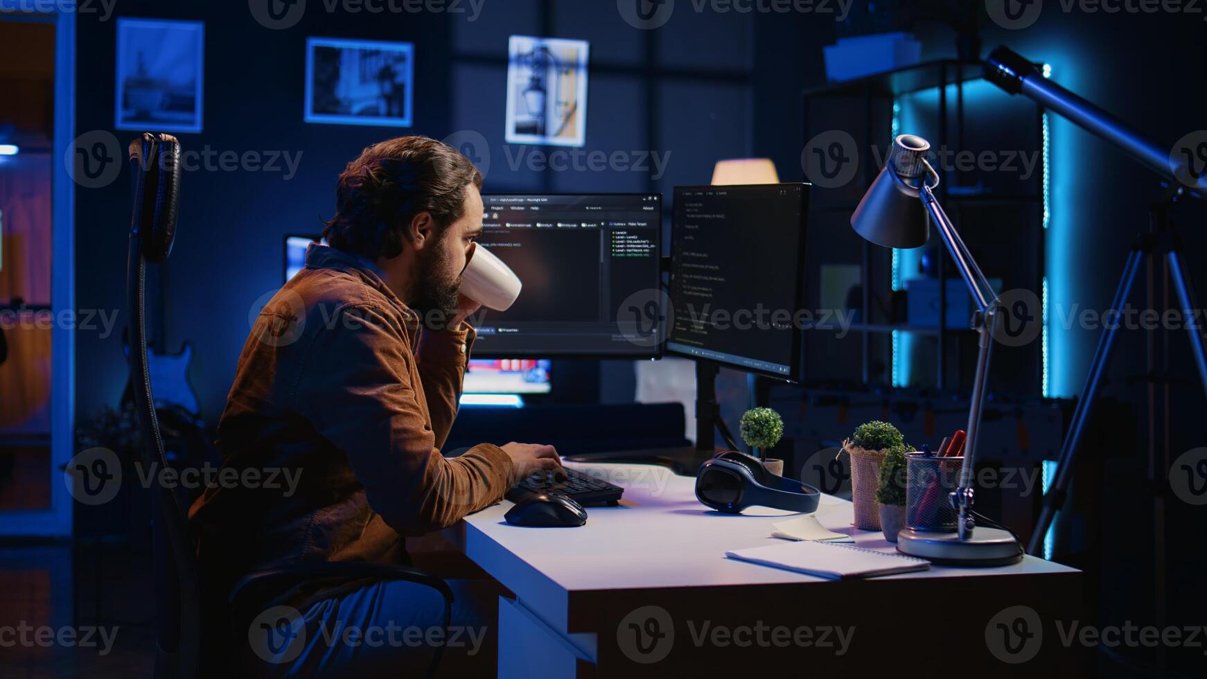Computer scientist drinking cup of coffee while developing code on PC using java programming languages. IT admin brainstorming ways of fixing database errors, enjoying hot beverage, camera B photo