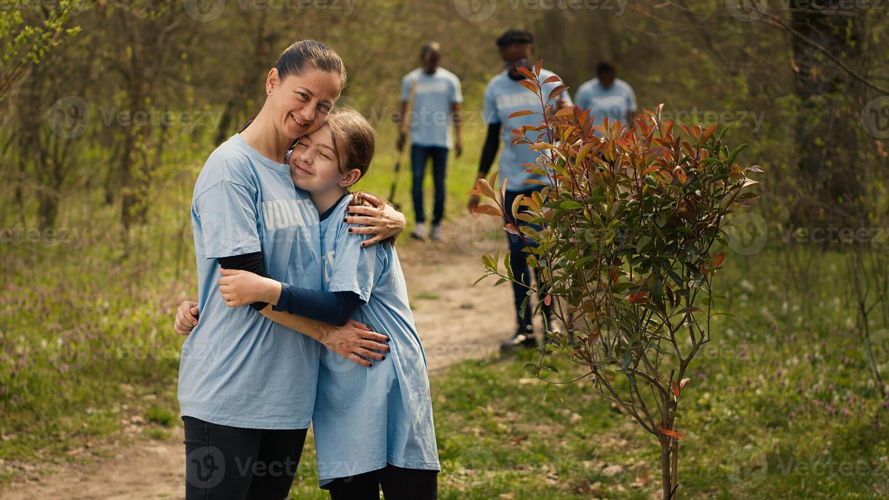 Portrait of mom and child protecting the environment by collecting rubbish, activism. People cultivating consciousness by eliminating plastic pollution and trash from the woods. Camera A. photo