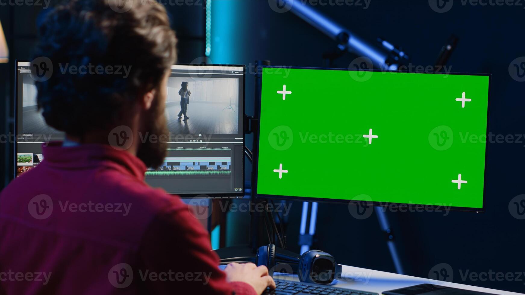 editor selects key frames to use in movie montage, using specialized software applications on green screen computer monitor. Freelancer using editing tools on chroma key PC, cutting footage photo