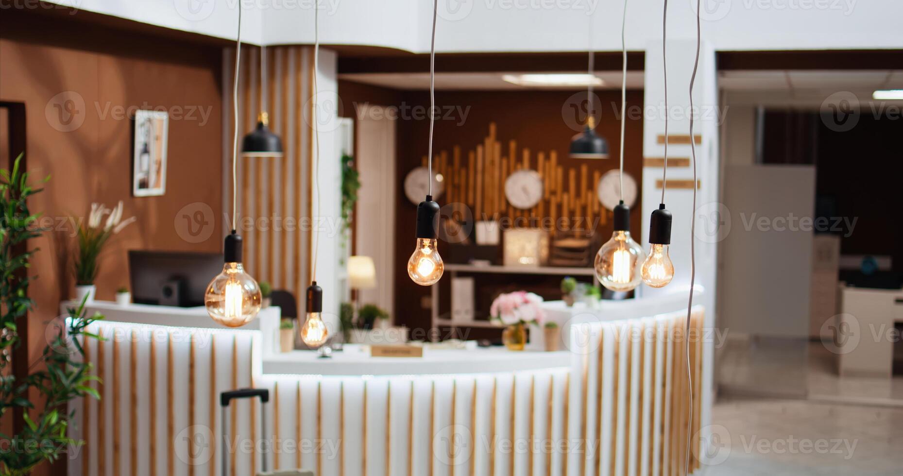 Beautiful lights and decorations in hotel lounge area creating cozy inviting atmosphere for guests and clients. Empty reception and front desk decorated with expensive furniture, five star resort. photo