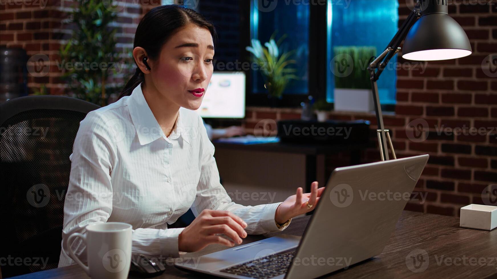Worker greeting colleagues during business meeting on videocall in office, using online teleconference to discuss company strategy. Employee participating in remote videoconference telework call photo