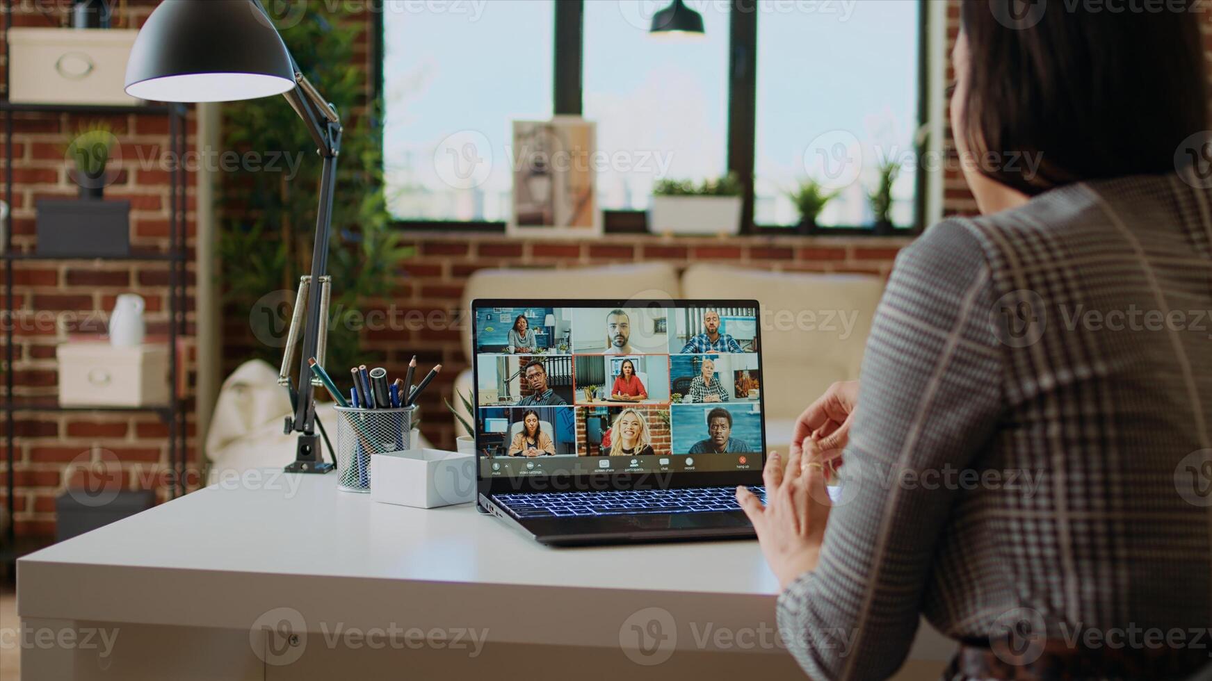 Remote employee in cozy apartment talking with coworkers during teleconference meeting. Teleworker at home participating in internet videocall with colleagues, camera A zoom in close up shot photo