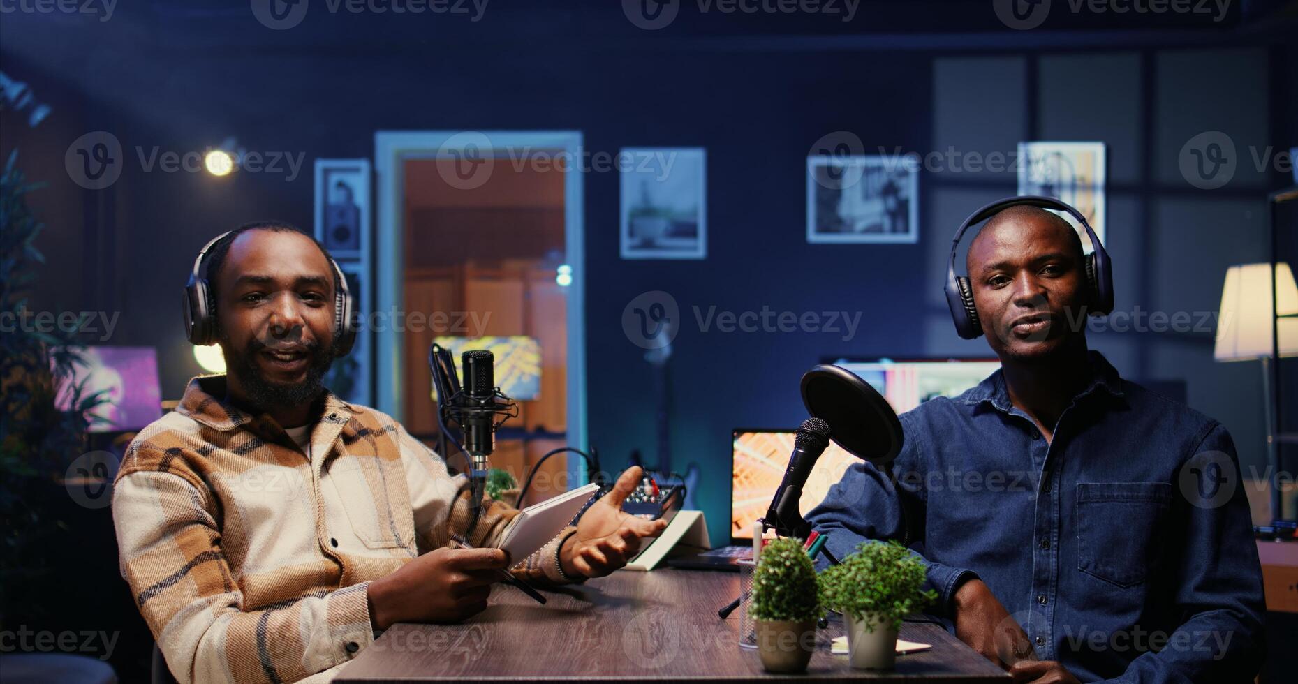 Man on podcast fist bumping presenter, starting marathon stream for humanitarian cause. Host greeting guest, ready to begin gathering donations from viewers during internet show photo