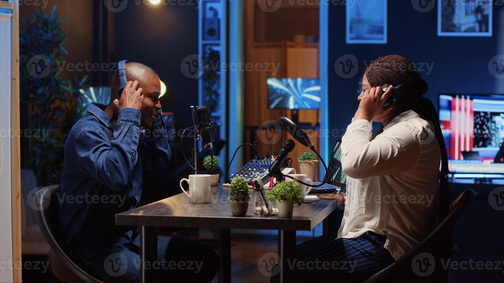 Cohosts arriving in studio, ready to stream podcast using professional vlogging gadgets to live broadcast debate on politics vlog channel. Podcasters meeting to film show, saluting each other photo