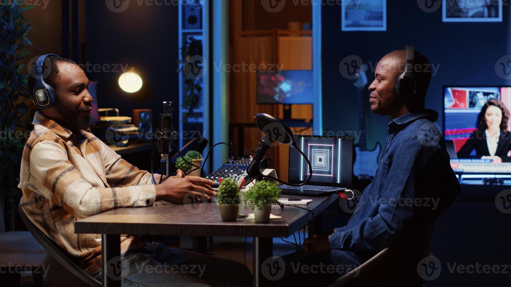 Man hosting podcast, using professional microphone and analog mixer to ensure high sound quality. Online show presenter talking with guest, broadcasting from apartment studio photo