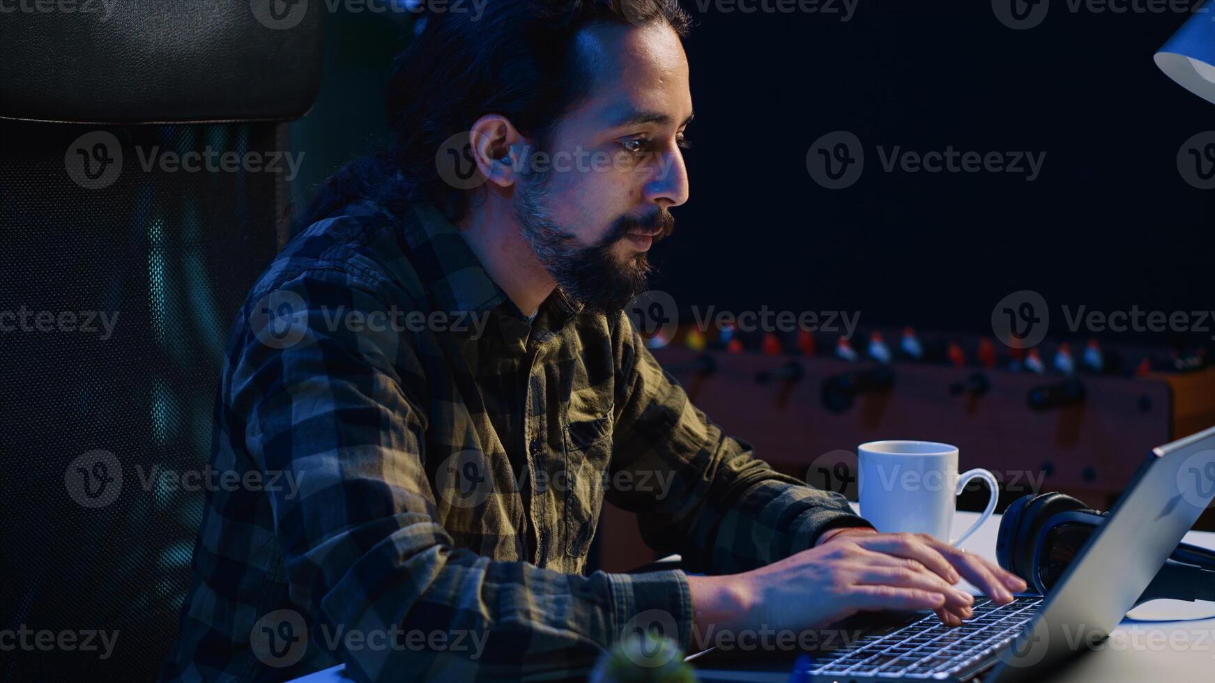 Cheerful man doing online shopping, typing credit card information on laptop keyboard at home. Joyful person adding payment method on website, excited to purchase stuff, camera A photo