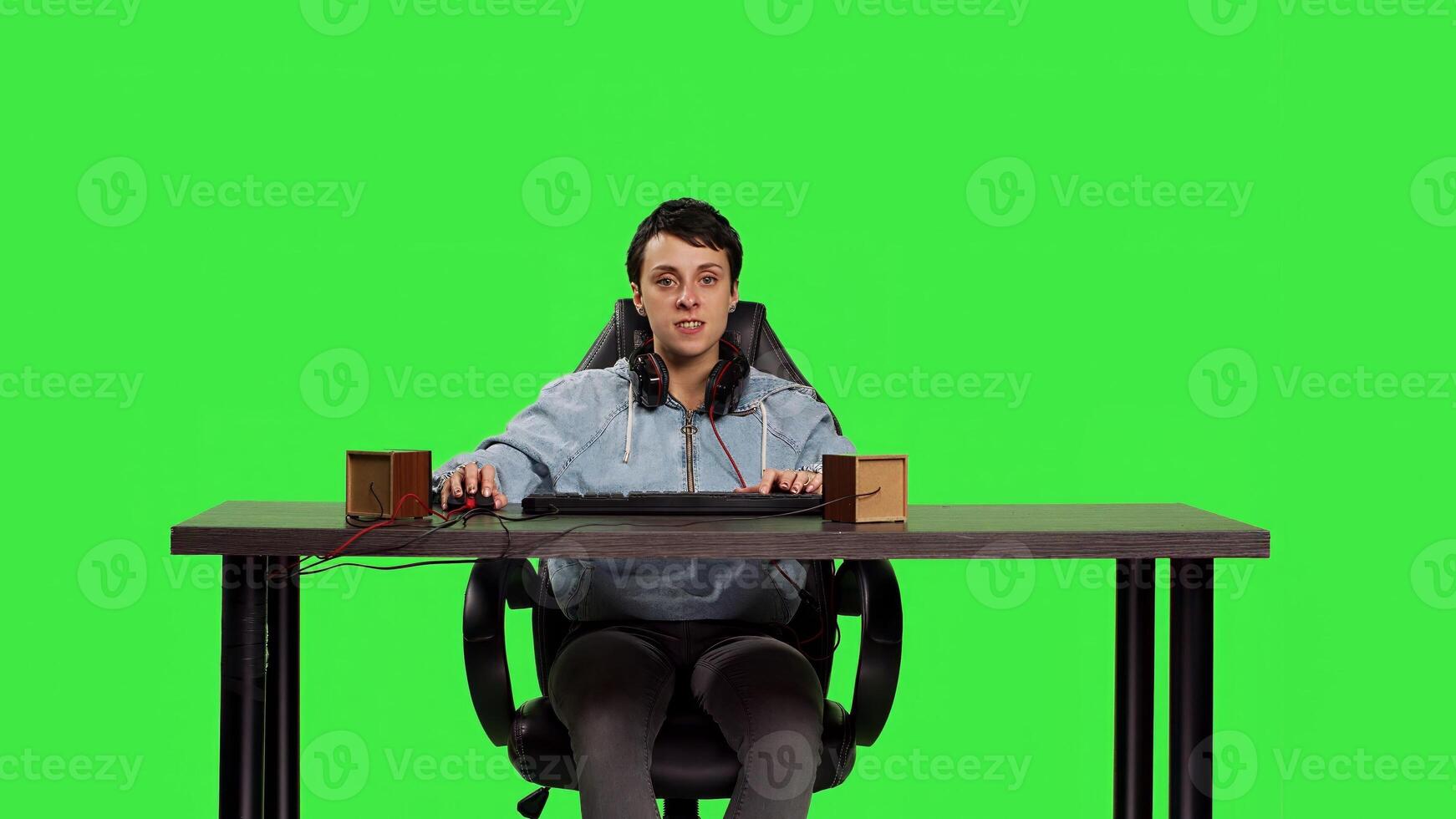 POV of sad person getting frustrated after losing championship online on computer, sitting at desk against greenscreen backdrop. Woman gamer feels furious and disappointed with lost round. Camera B. photo