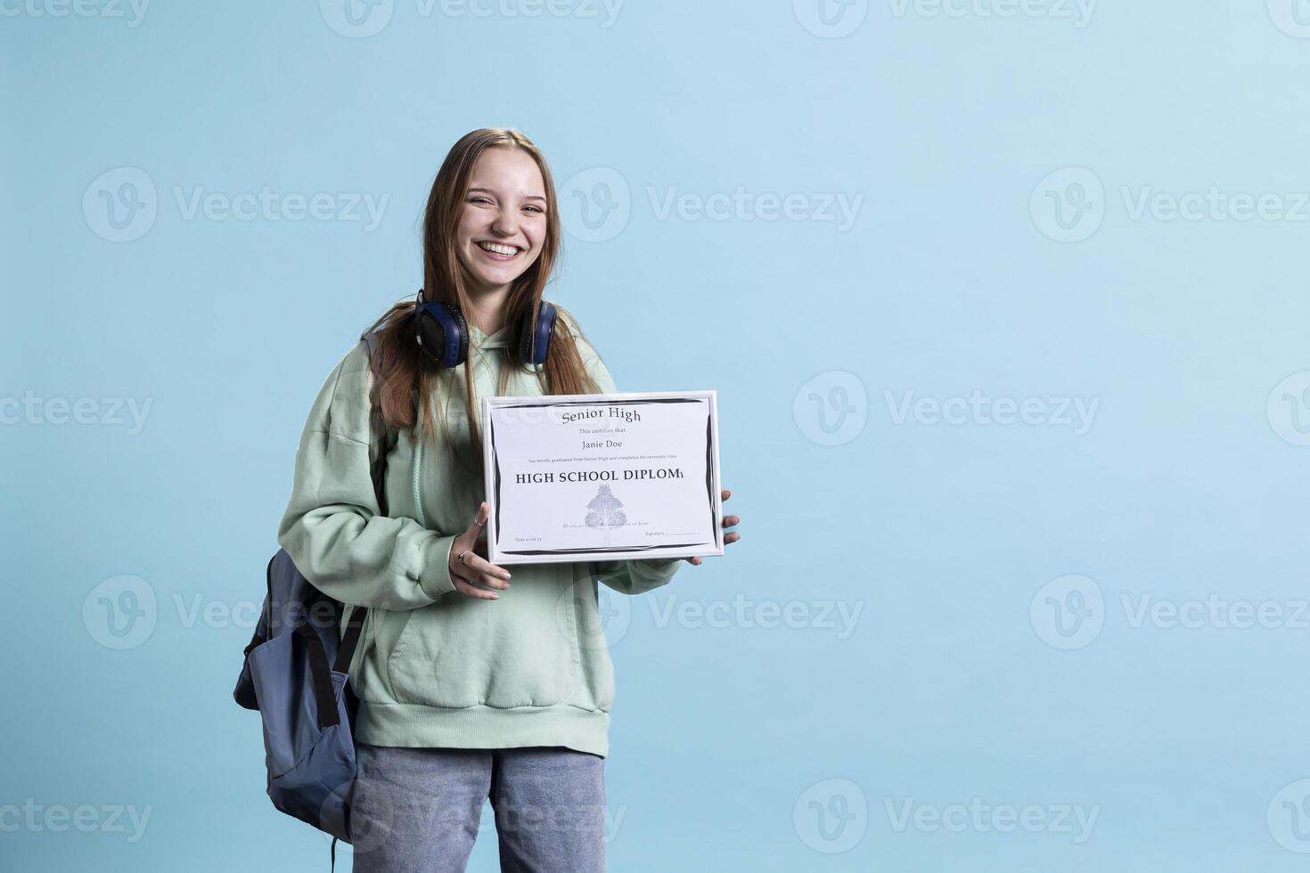 Portrait of smiling student holding high school diploma, celebrating passing classes with high marks, attending graduation ceremony. Happy young girl delighted about receiving certification photo