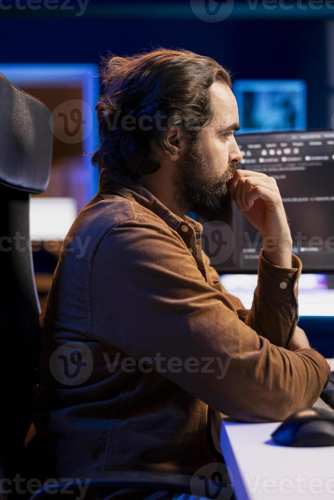 Software technician filtering malicious traffic from cybercriminals attempting to corrupt company data. IT admin working on computer, preventing malware and phishing attacks photo