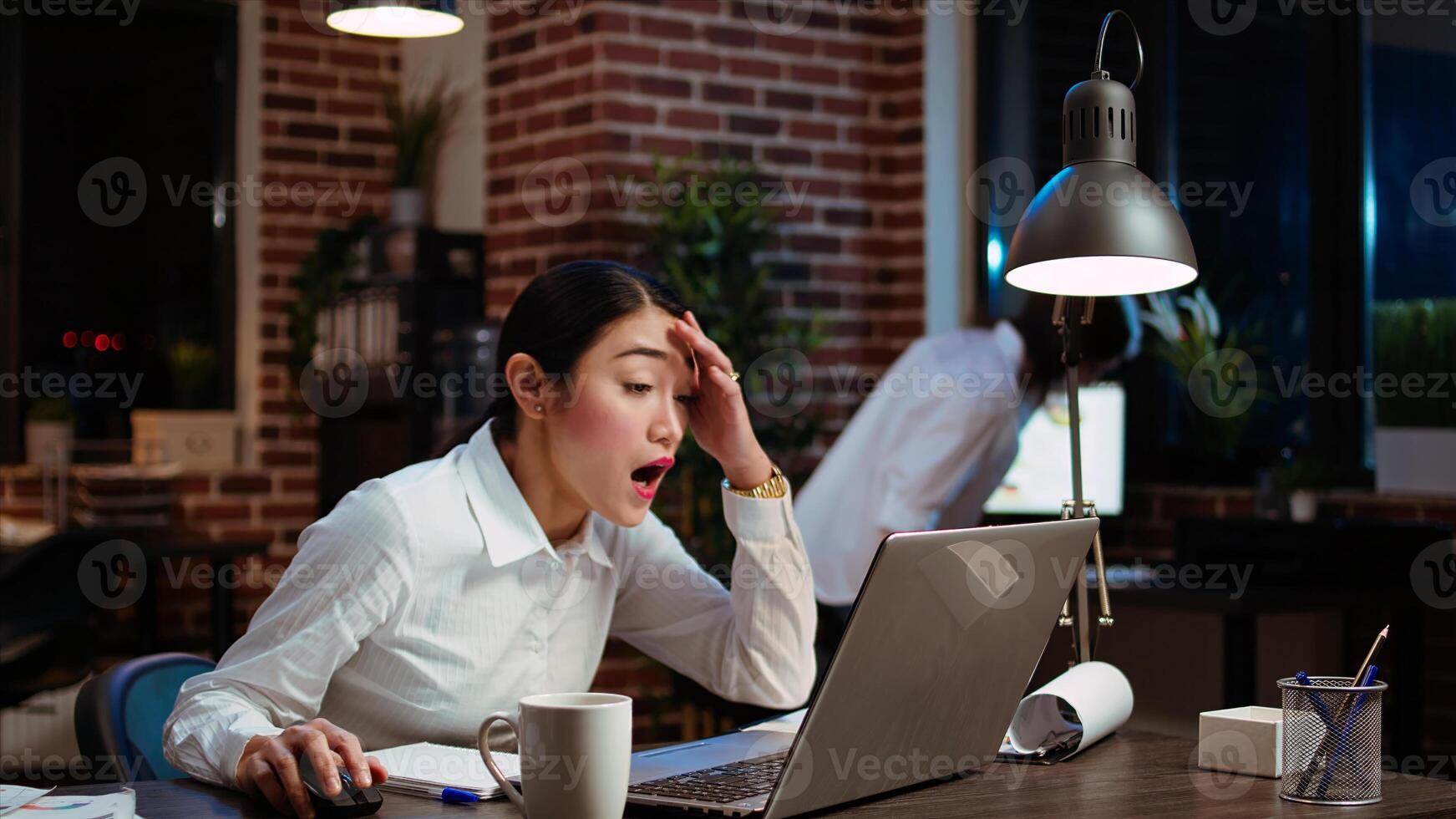 Company accountant stressed by complicated sales report needed to plan business development. Office employee sighing in frustration, feeling overworked while using laptop to do project research photo