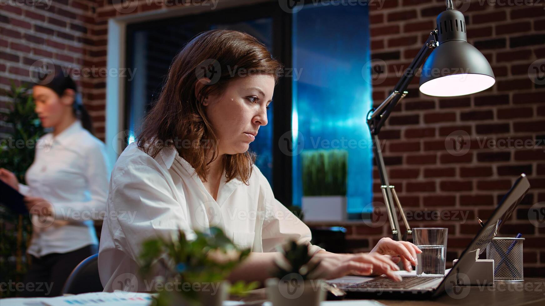 Businesswoman creating marketing project plan on laptop, writing necessary steps. Office employee working on strategy research to create financial development for company, camera A photo