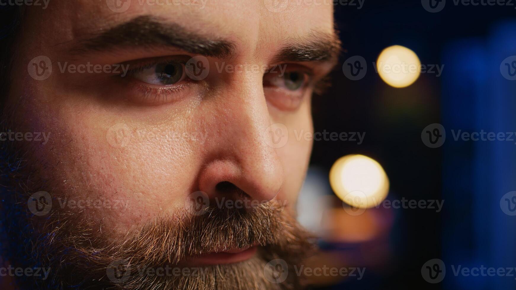 Developer in home office concentrating hard while doing coding on computer, extreme close up shot. Focus on IT admin paying close attention to screen while writing lines of code, camera B photo