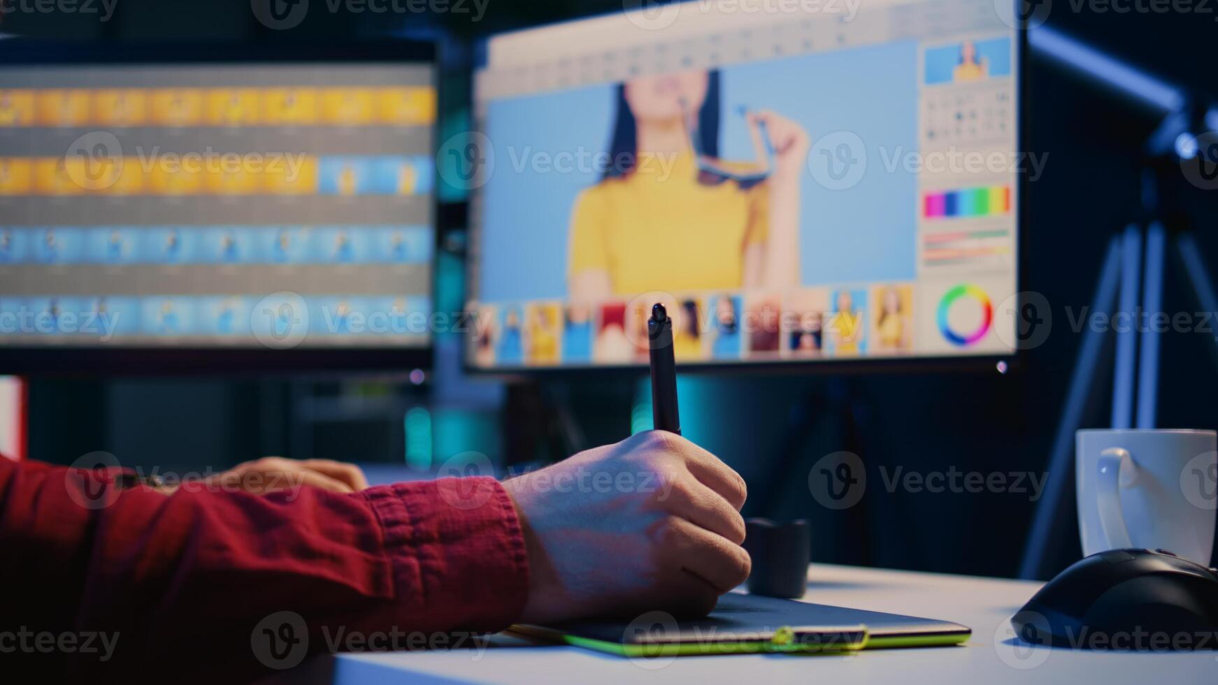 Photo editor editing images, doing color correction in post production company using graphic tablet. Photographer fixing overexposed pictures with stylus on touchscreen device, close up shot