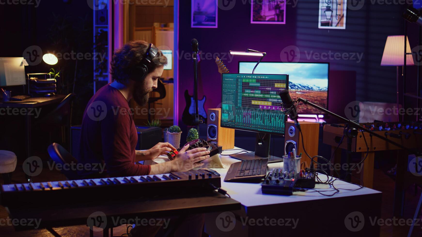 Music engineer operates recording equipment in home studio, working with mixing consoles and digital audio workstations to create sound effects on soundtracks. Production techniques. Camera B. photo