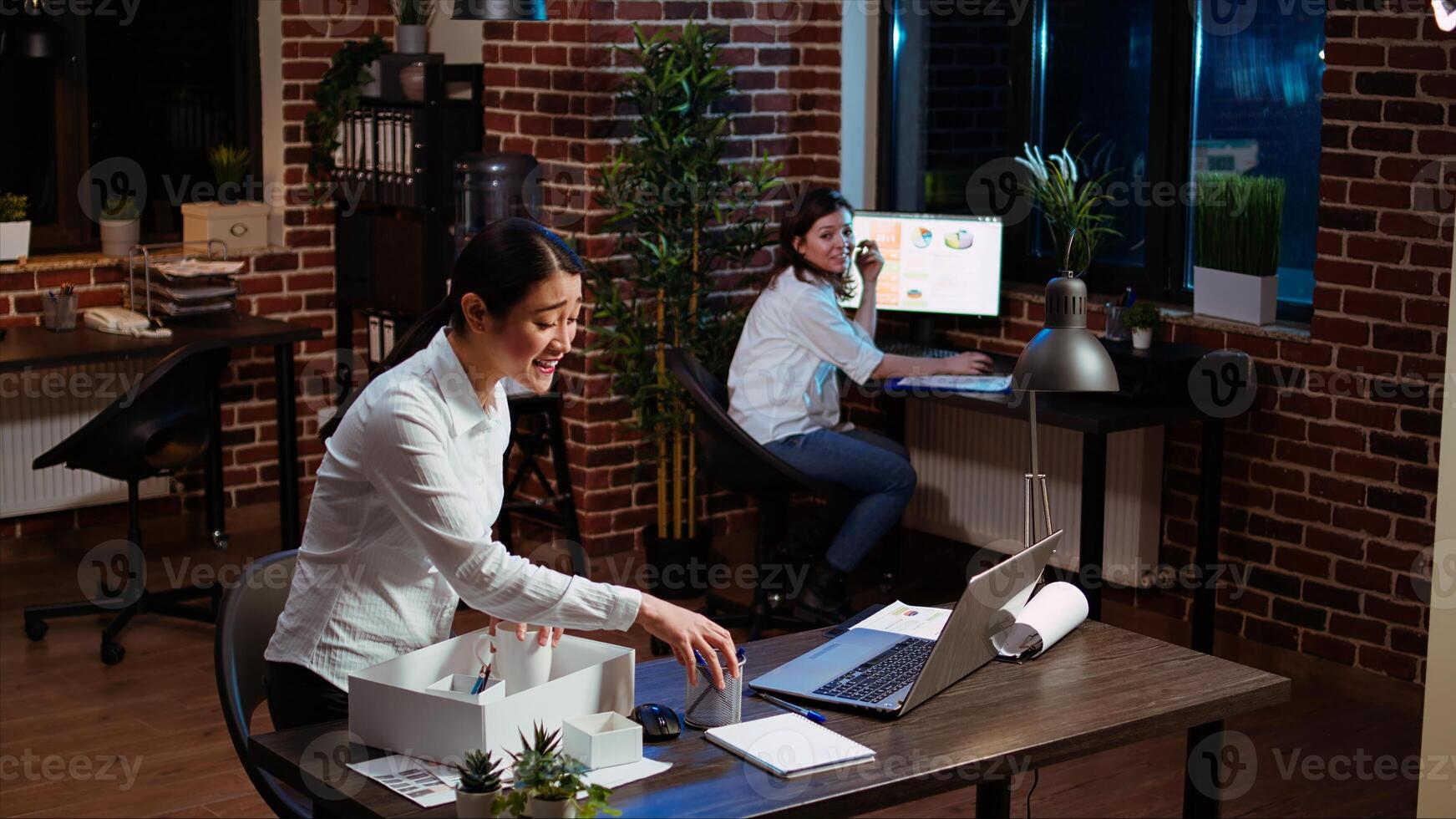 Woman dancing and singing while packing desk belongings, excited to change offices after job promotion. Joyful employee being advanced in company hierarchy, celebrating, saluting colleague, camera A photo