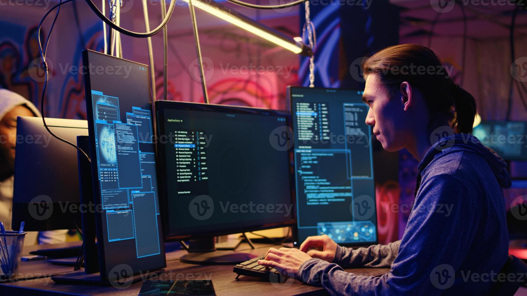 Tracking shot of asian hacker arriving in hidden underground shelter, prepared to launch DDoS attack on websites. Cybercriminal starting work on script that can crash businesses servers photo