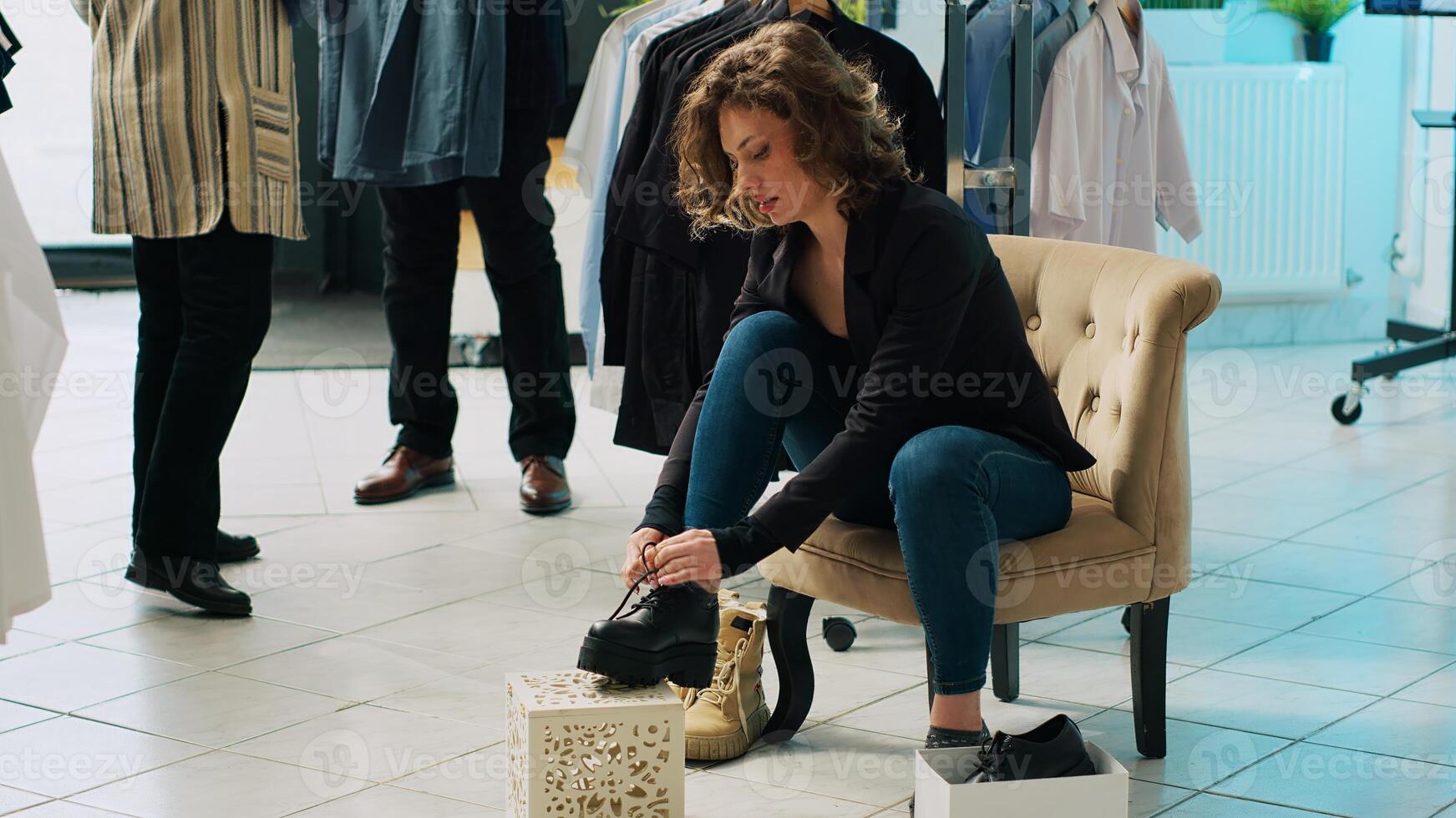 Trendy customer trying on elegant shoes with laces at fashion boutique, looking to buy new footwear for an office style outfit. Woman on shopping spree at department store. Camera A. photo