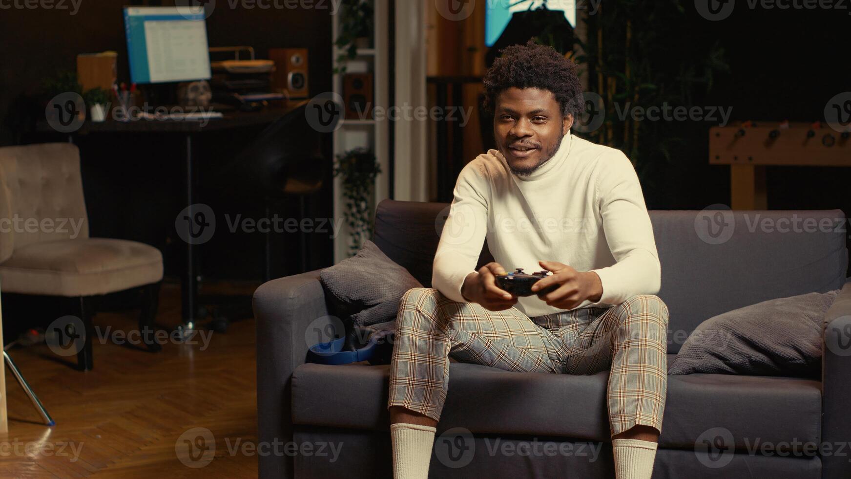Cheerful gamer feeling excited after finally defeating all enemies and winning, celebrating, punching air. Joyful man congratulating himself after finishing videogame on gaming console photo