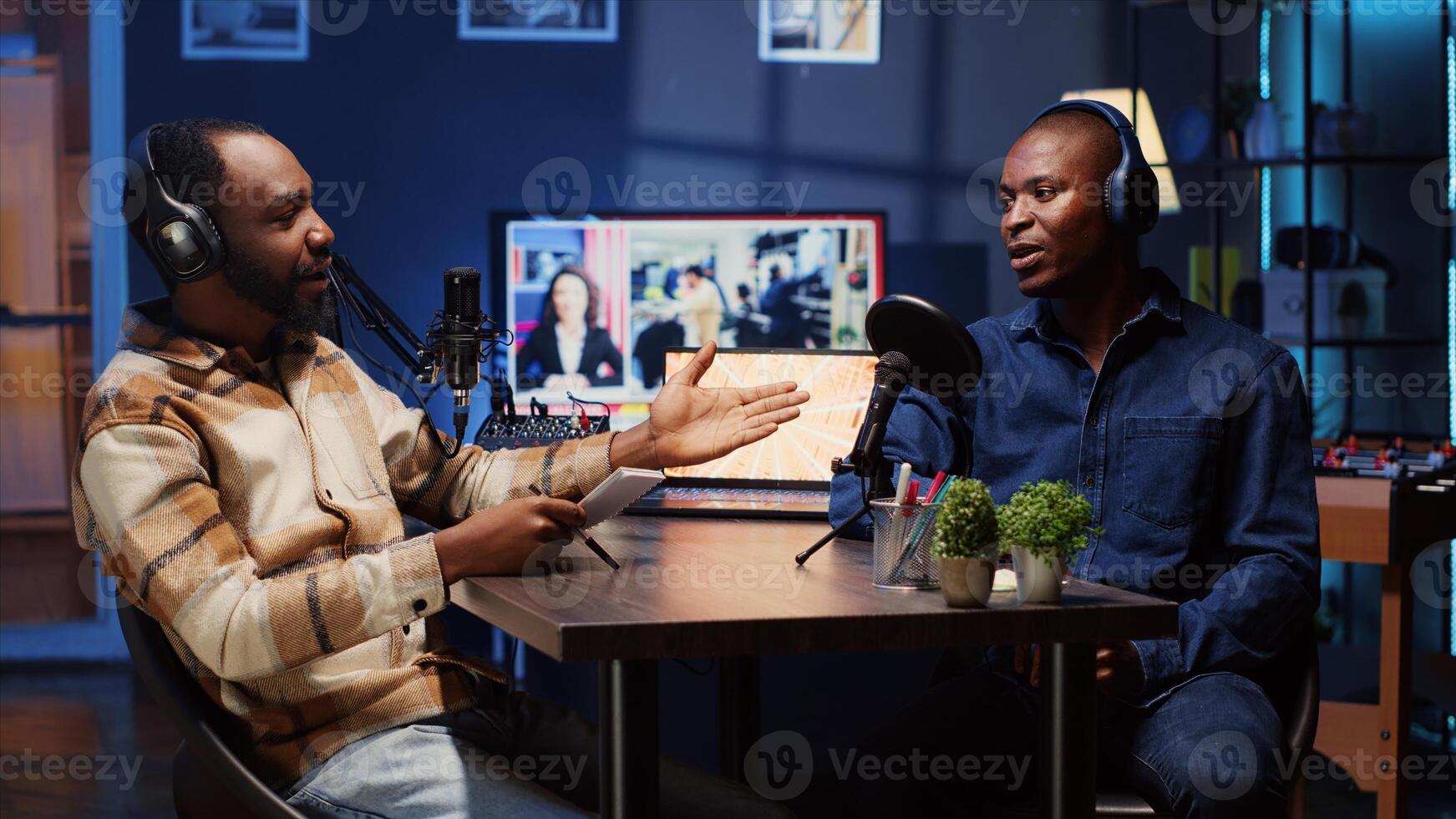 Podcast presenter having live discussion with man, using headphones to review music together. Influencer enjoying chat with guest, streaming it for audience on internet show photo