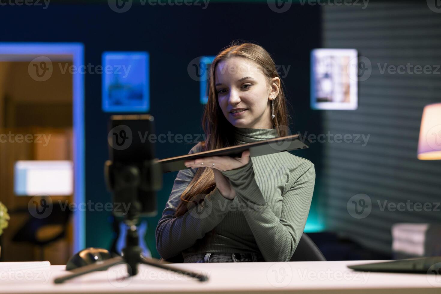 Cheerful girl excited to analyze wireless keyboard received from sponsor, doing honest review for online streaming channel. Upbeat media star excited to review computer peripherals brand photo
