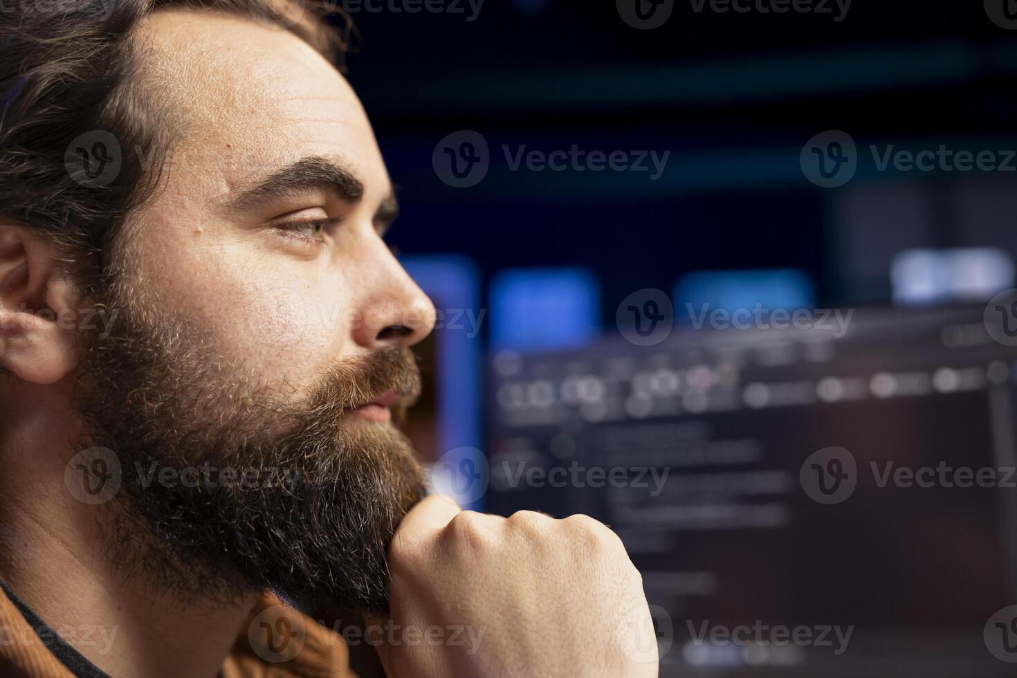 Freelancing programmer working from home, designing and developing software applications. IT specialist looking at desktop PC monitor, implementing and maintaining company systems, close up photo