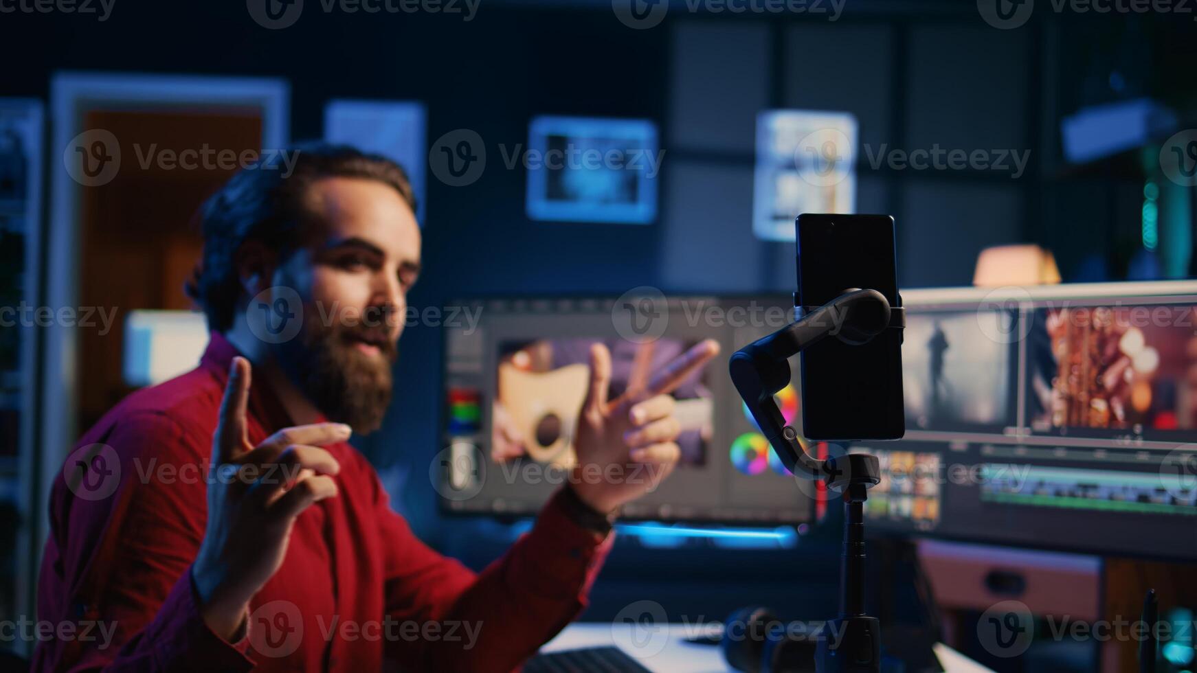 Smartphone on tripod used by videographer to teach internet viewers to create visual effects for projects. Expert filming online tutorial with mobile phone about editing footage photo