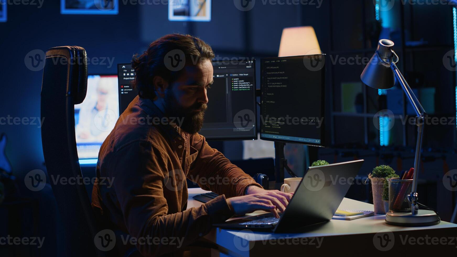 Computer scientist putting headphones on while developing code on PC, making time pass faster during remote job shift. IT admin doing multitasking in home office while listening music, camera A photo