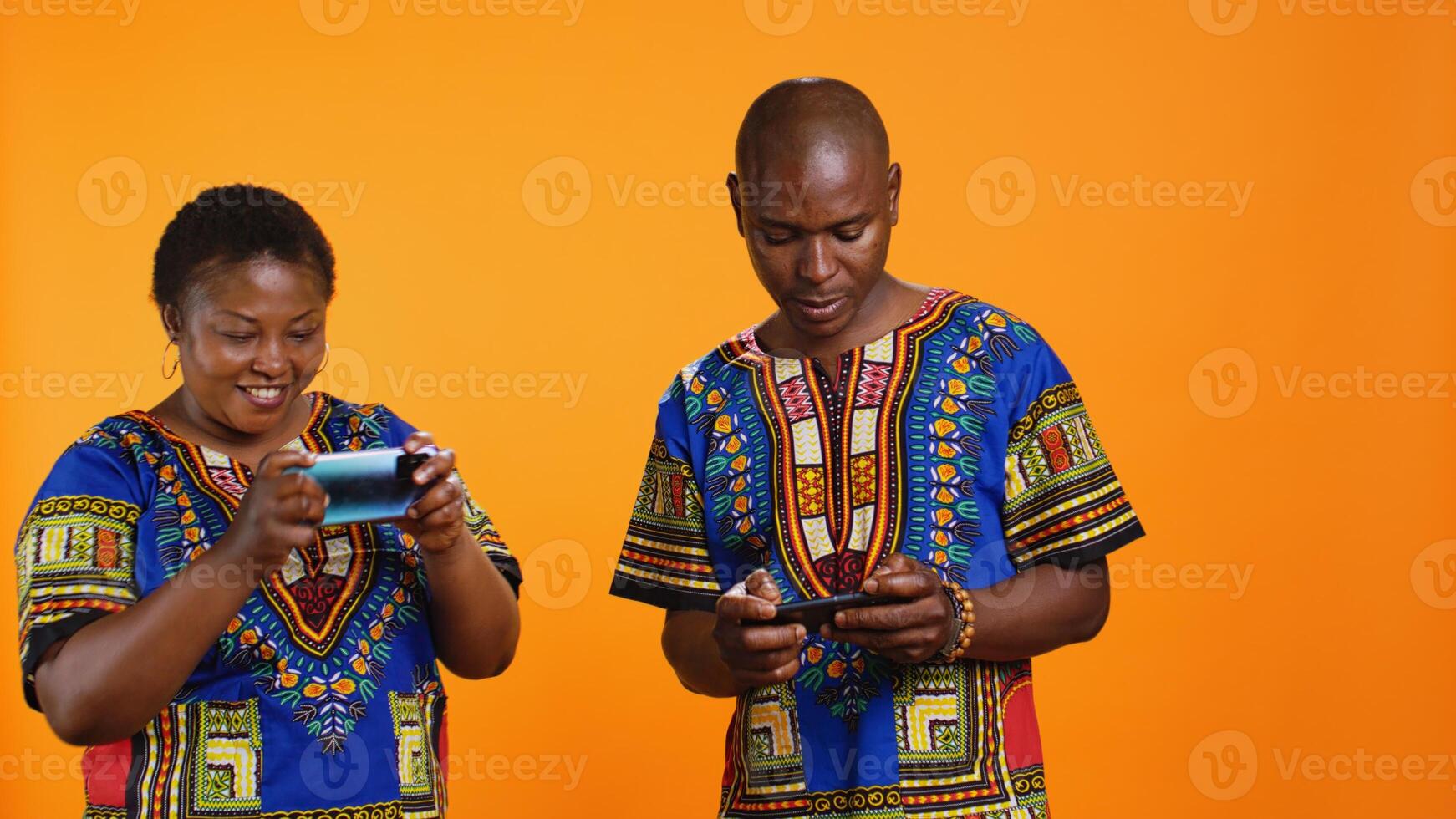 Cheerful woman winning videogames competition in studio, feeling happy about victory while she plays online with her husband. Young man feeling frustrated about losing to his girlfriend. photo
