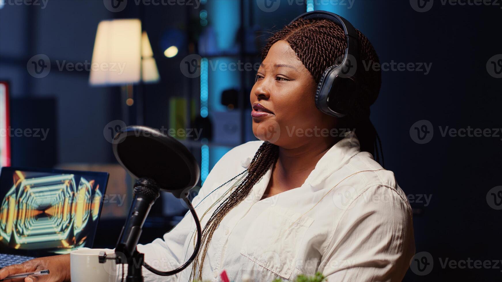 Guest on online podcast show telling interesting story to host, captivating viewers watching during live broadcast. African american woman in studio sharing facts, surrounded by audio tech photo
