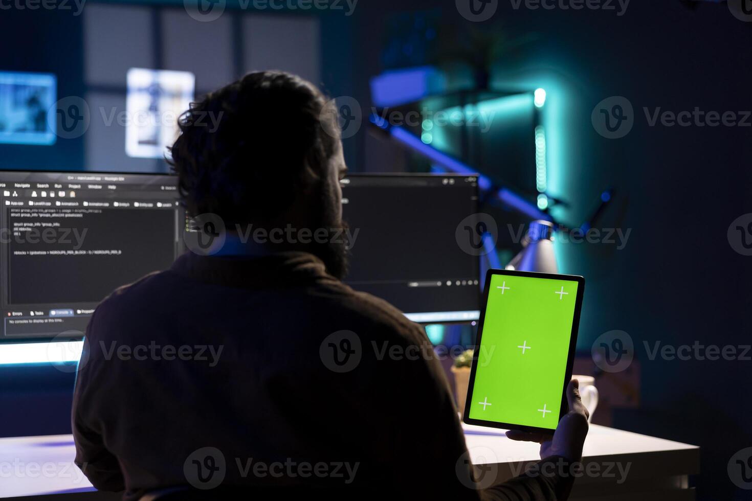 Cybersecurity expert using isolated screen tablet to look for security vulnerabilities and injected malware. Programmer installing fortified code on mockup portable device to prevent cyber attacks photo