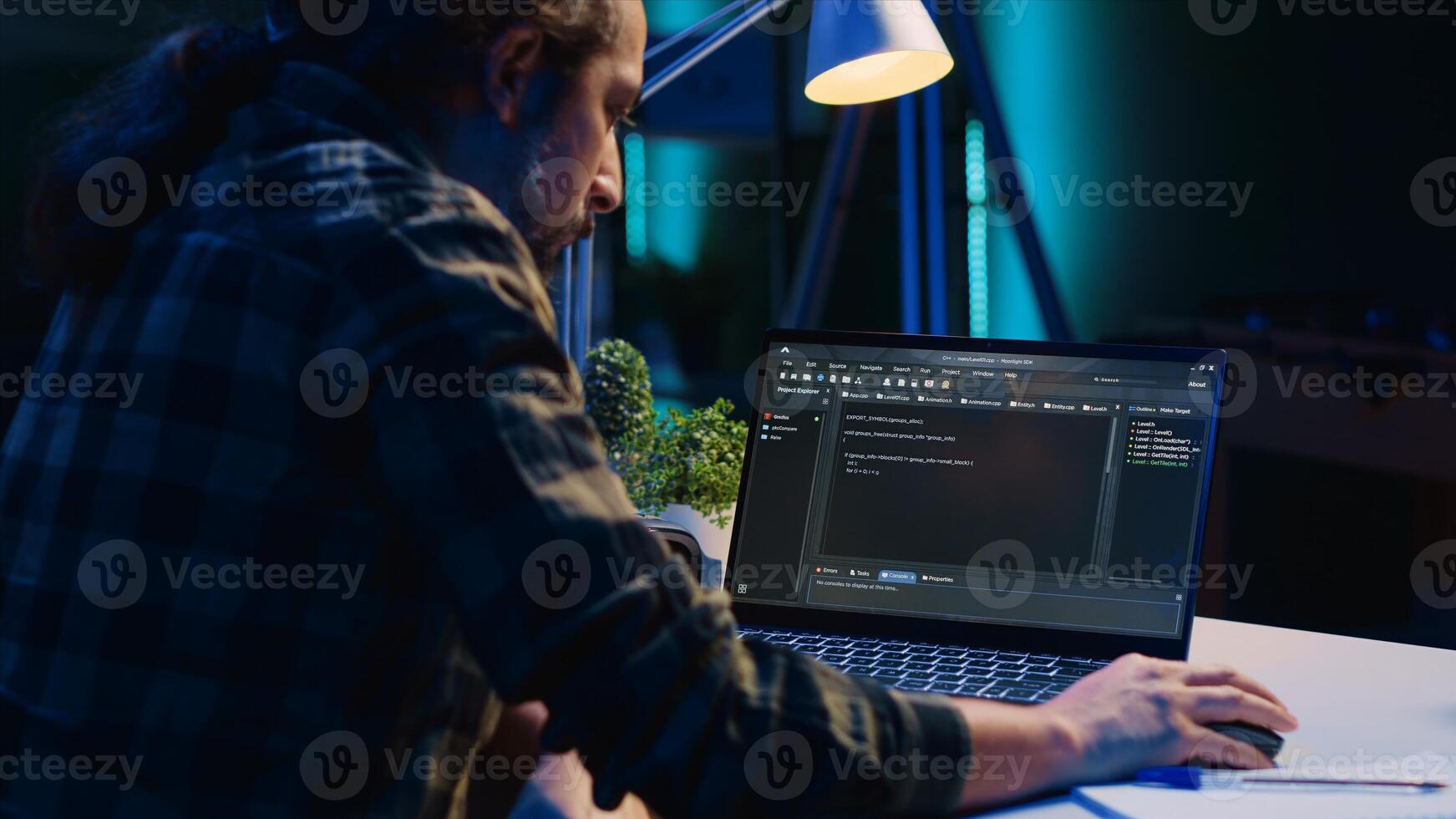 Skilled computer scientist writes code on laptop screen while in living room office using programming languages. Self employed IT specialist working on fixing database errors from home, camera A photo