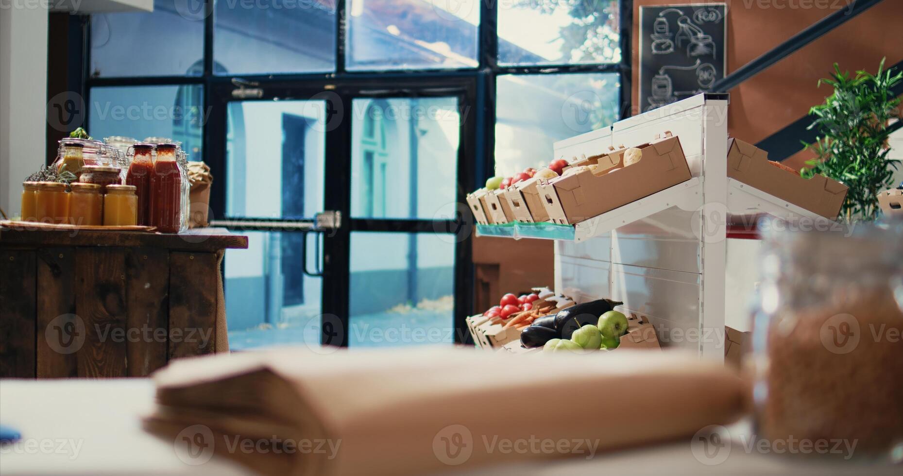 Eco friendly grocery store selling organic locally grown produce and homemade sauces of dressings. Empty supermarket filled with natural farming goods and bulk items in glass jars. Handheld shot. photo