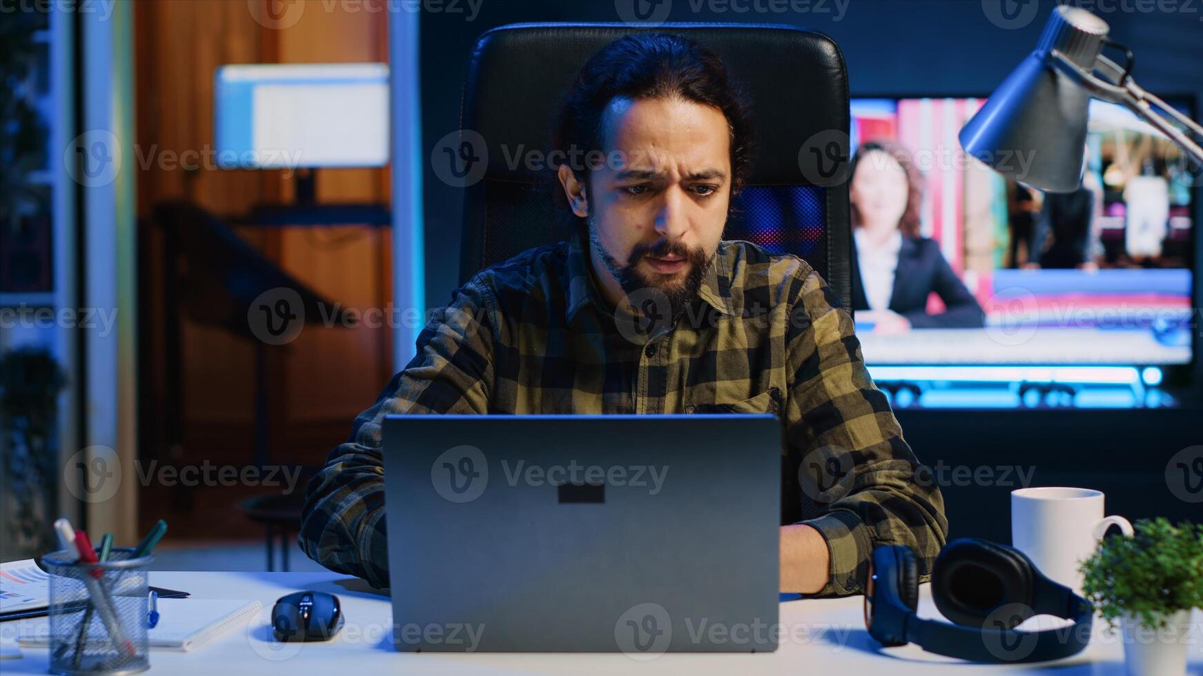 Remote employee arriving in stylish apartment personal office, starting important job tasks. Focused teleworker typing on laptop keyboard, beginning work shift at home, camera A photo