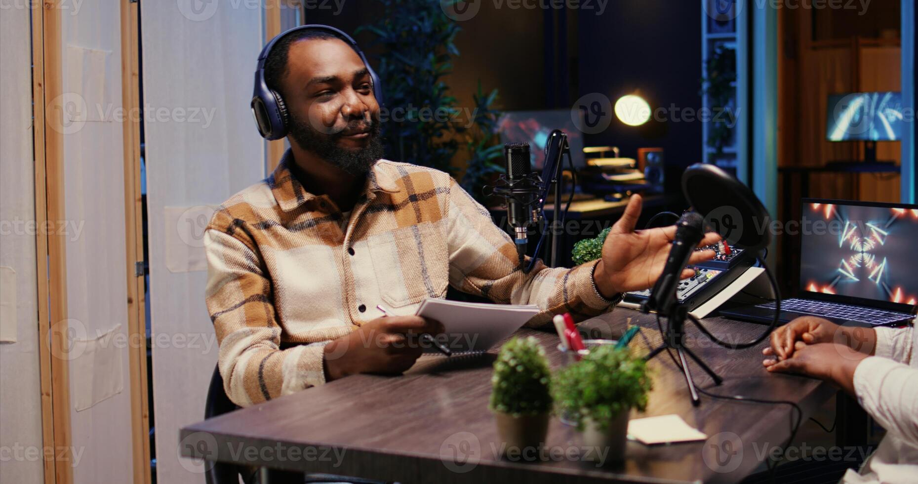 Show host talking with guest in studio, listening to opinion on current events, filming for social media. Influencer presenting woman to audience before starting podcast photo