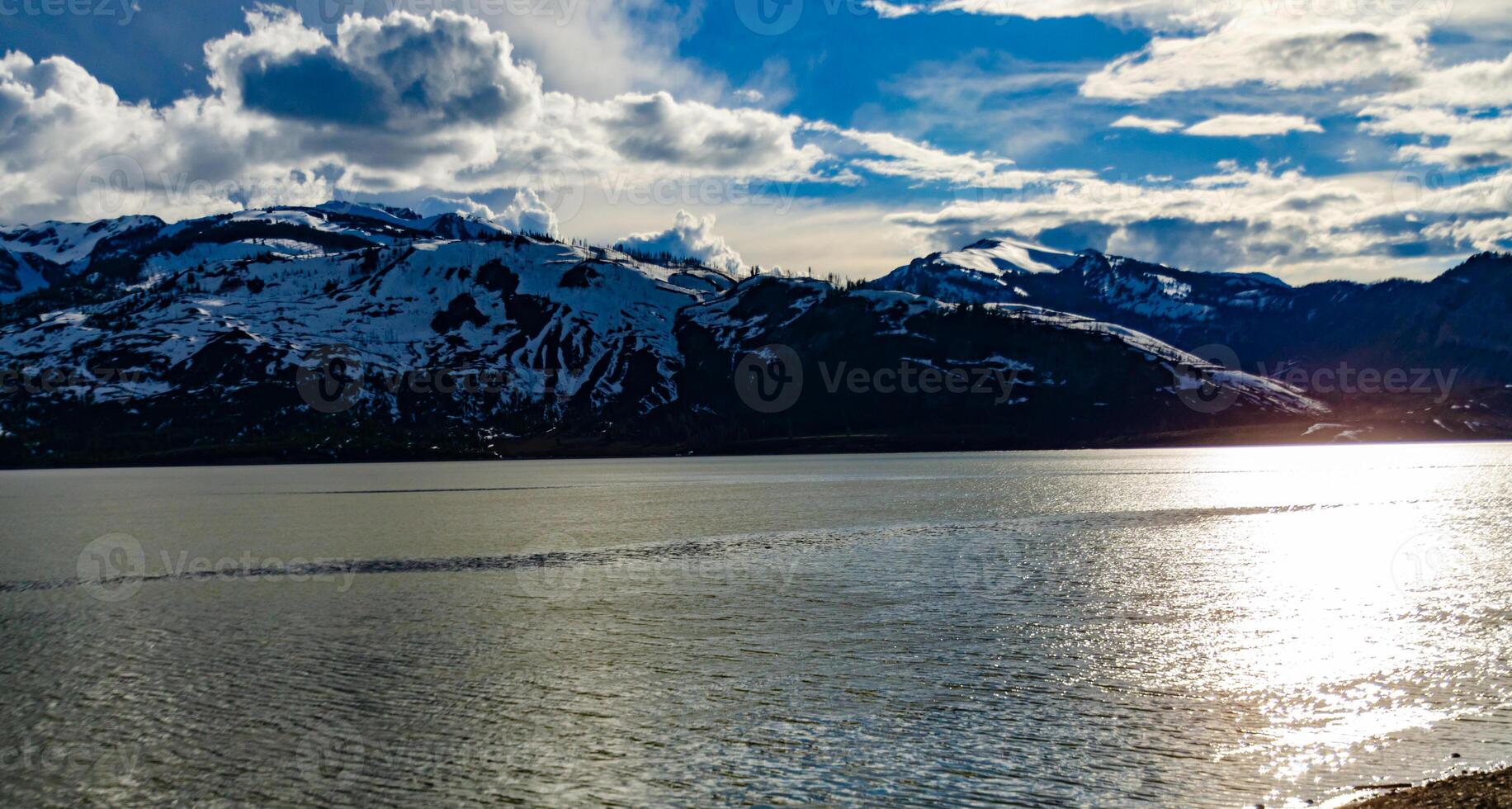 View of the snow-capped mountains in the clouds near the lake Gren Titon, US photo
