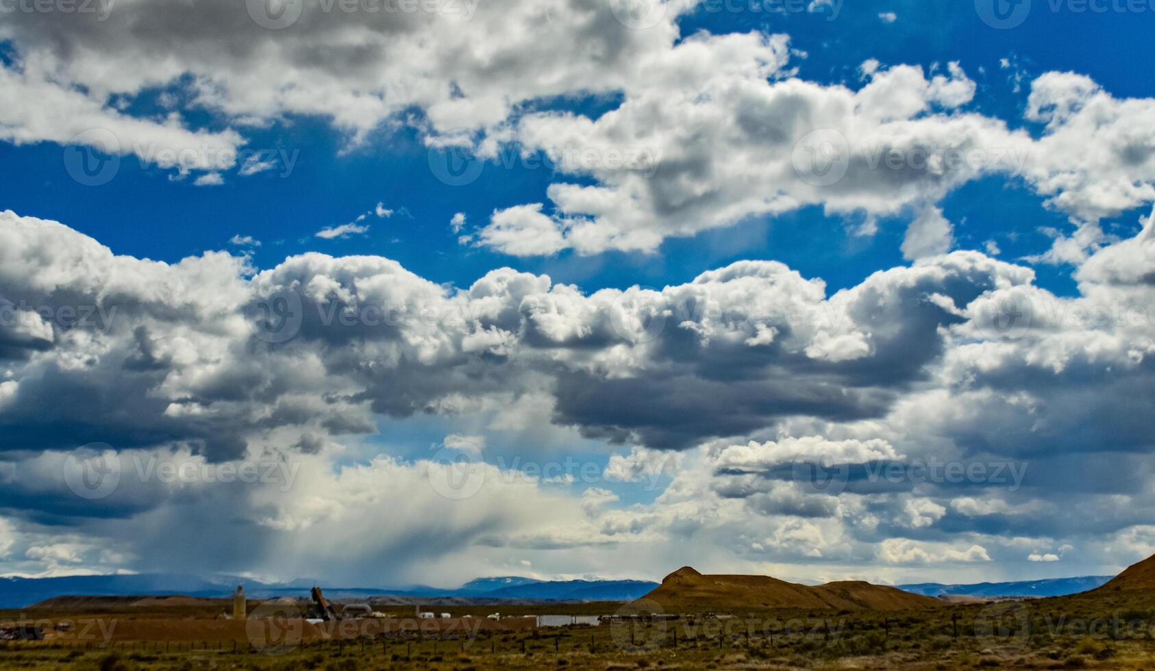 Rain clouds during the day over the plains in Utah, US photo