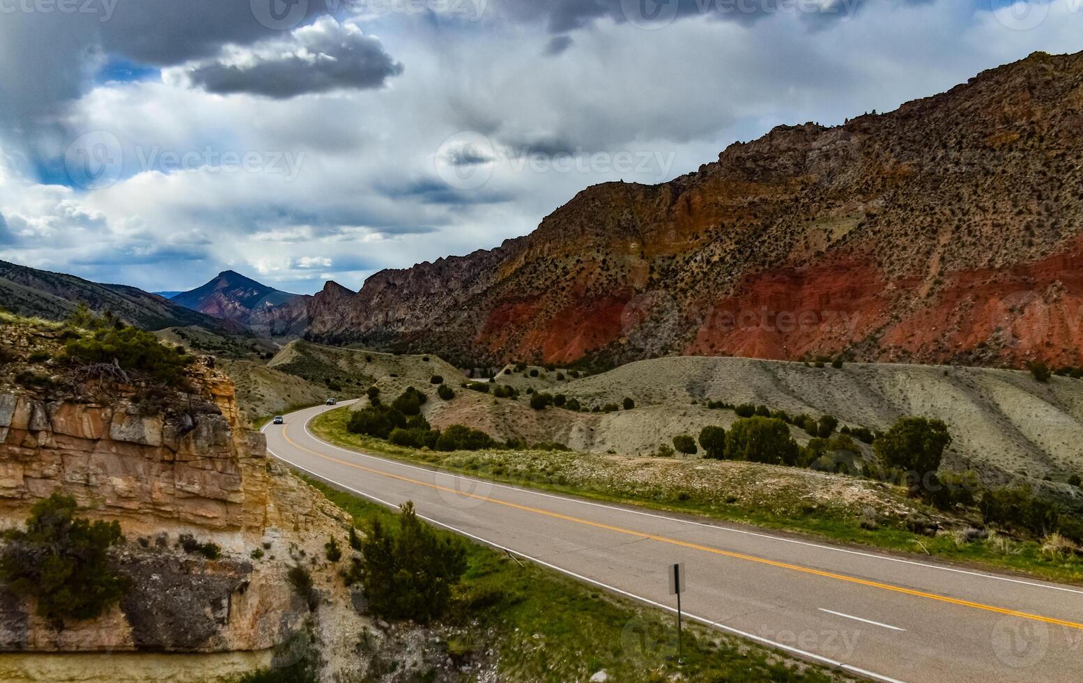 Road among red layered rocks in Utah, US photo