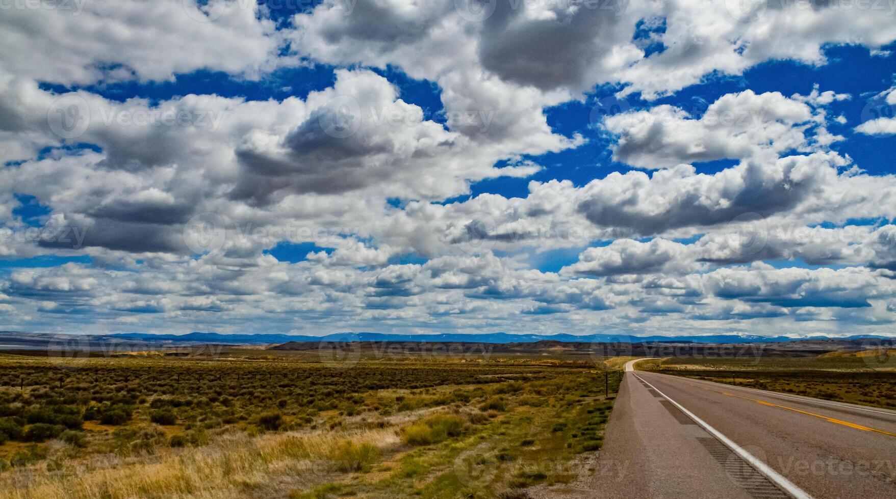 Rain clouds during the day over the plains in Utah, US photo