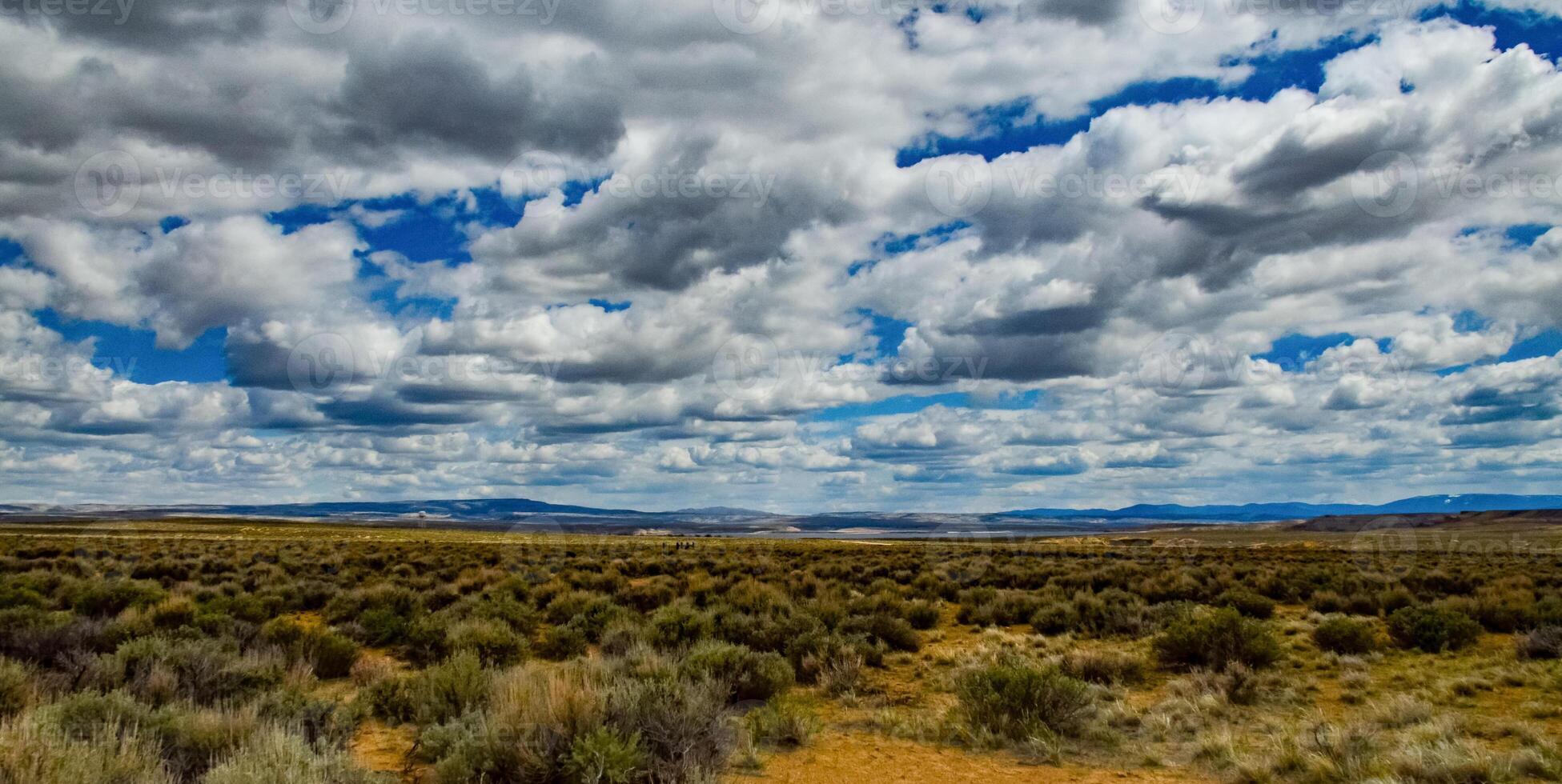 Rain clouds during the day over the plains in Utah, US photo