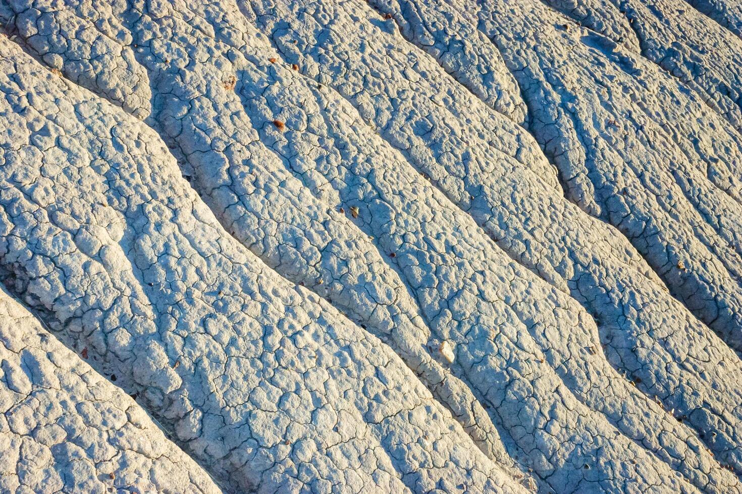 Clay mountains, zazytymi streams of water of the unique blue-hued badlands in Petrified Forest National Park, Blue Mesa, AZ photo