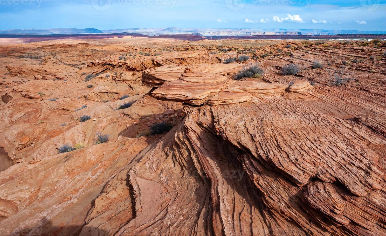 Layered weathered red sandstone rock formations photo
