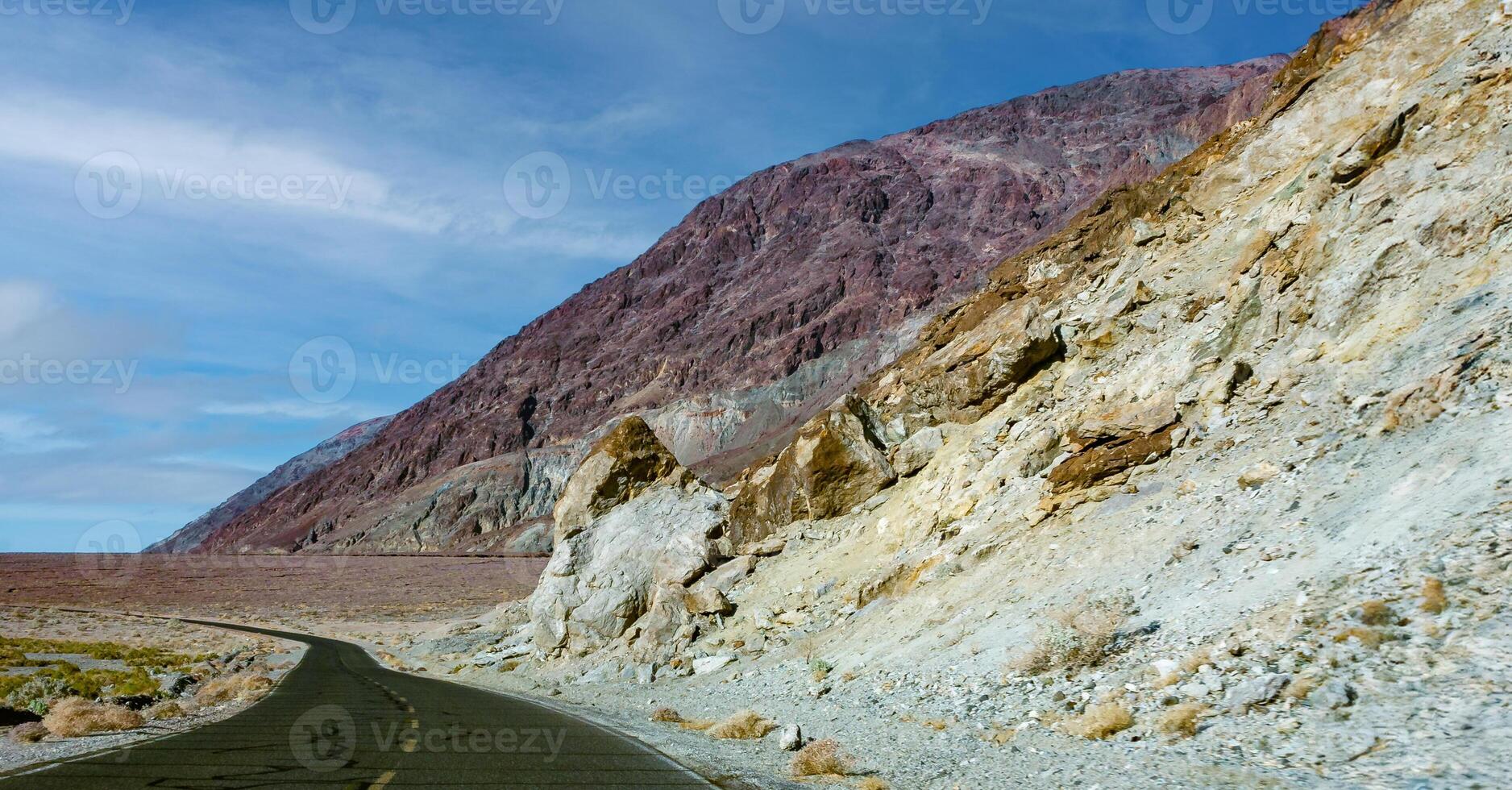Road along Mountains with colorful rocks in Death Valley in the Arizona desert. photo