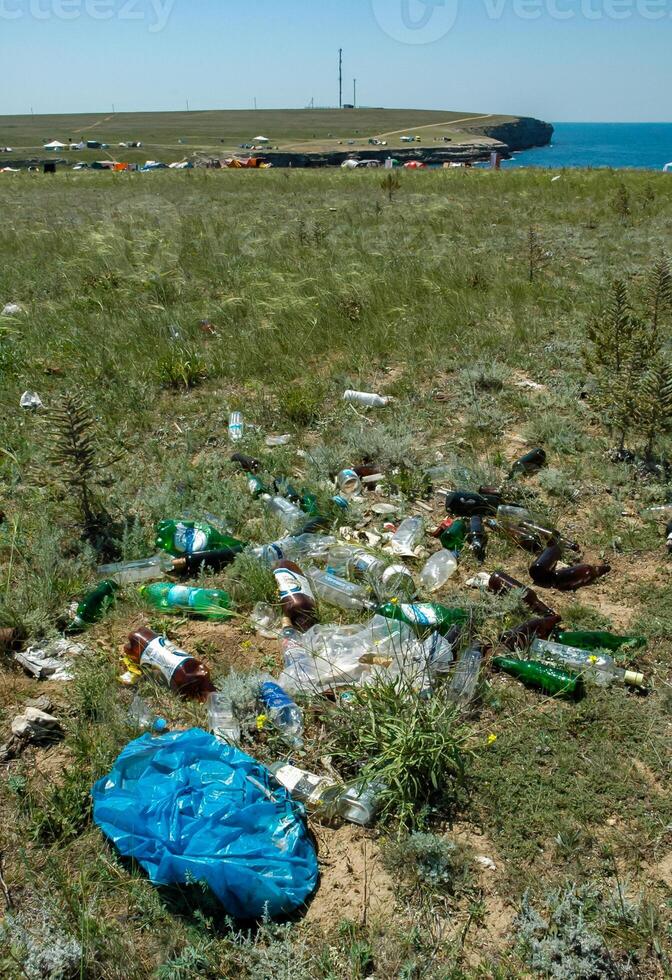 UKRAINE, CRIMEA - AUGUST 02, 2009 Pollution of the steppe nature with plastic household waste photo