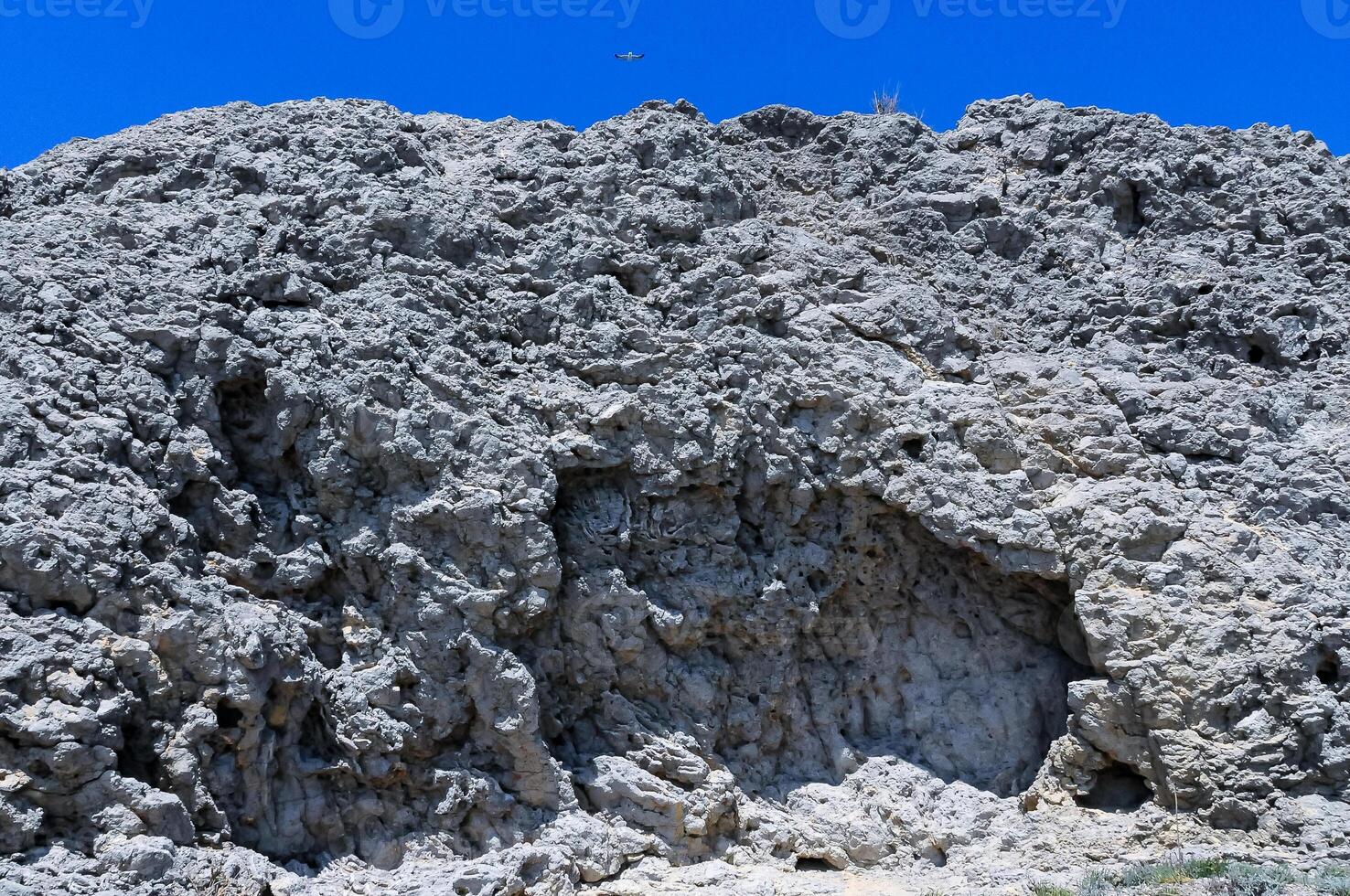 Destruction and weathering of hardened volcanic lava on the mountain slope of an ancient volcano photo